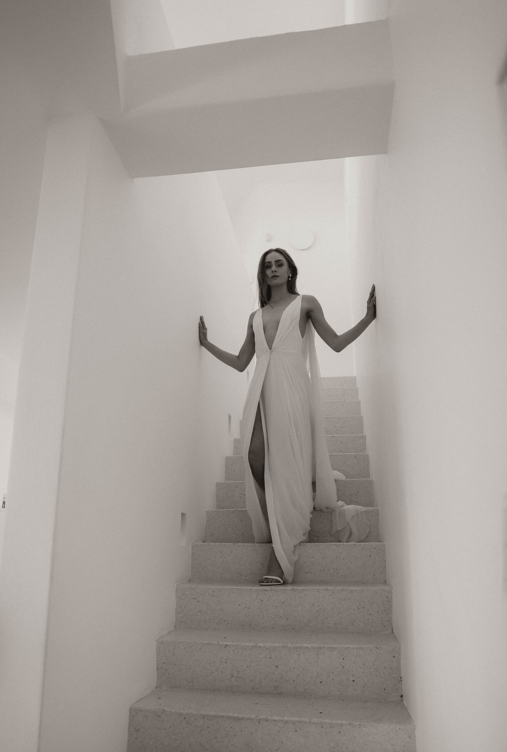 editorial bride walking down the stairs in her Santorini Greece elopement dress