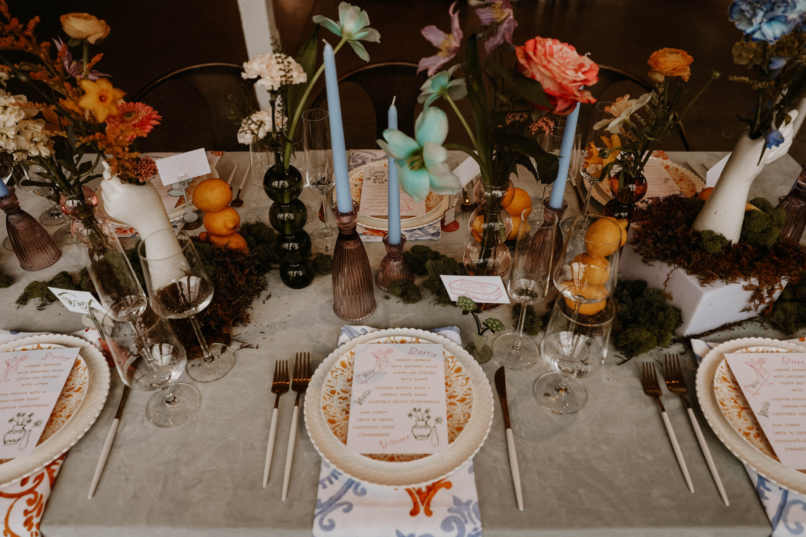 a colorful and whimsical table scape with food card during a colorful spring wedding 