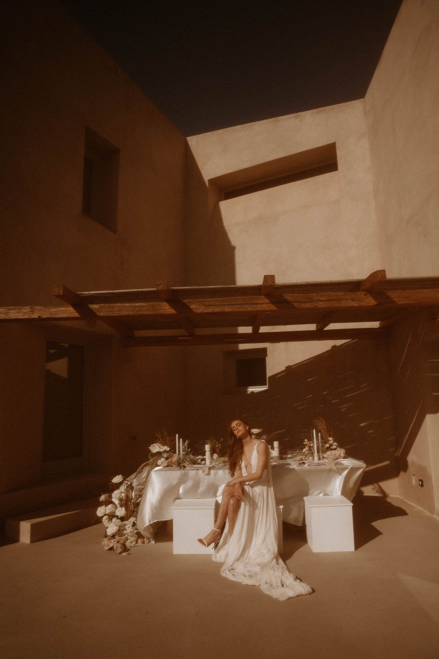 vintage edit of bride sitting at elopement table during Santorini Greece elopement
