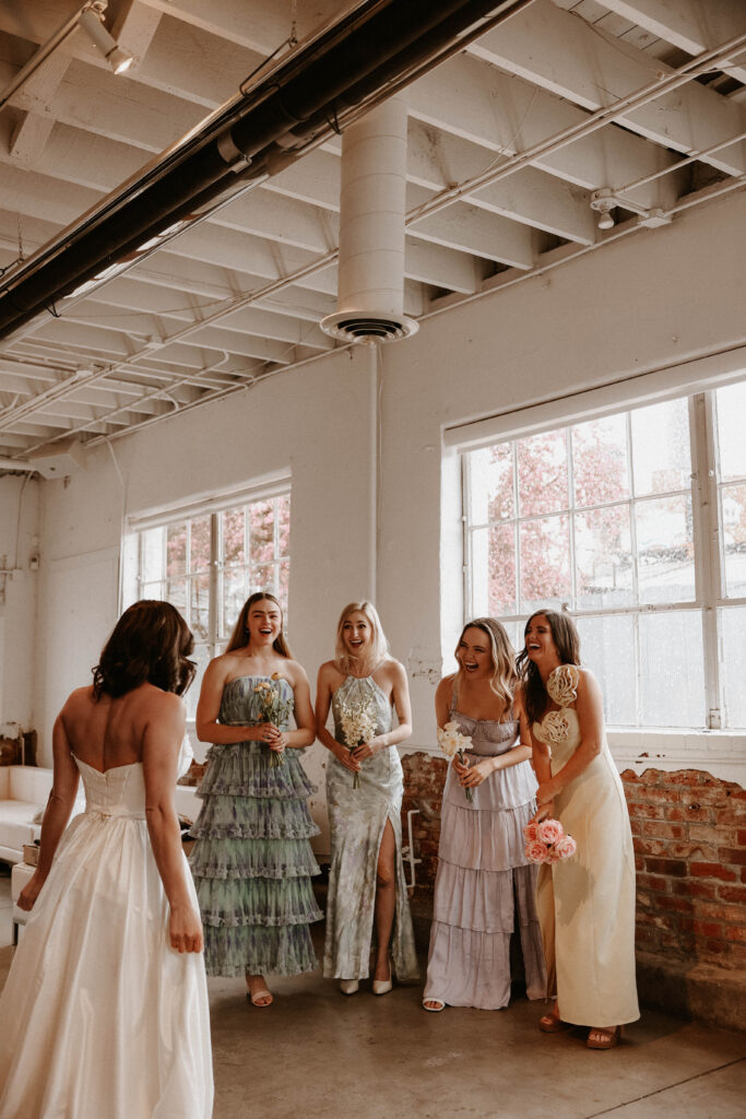a bride's first look with her bridesmaids