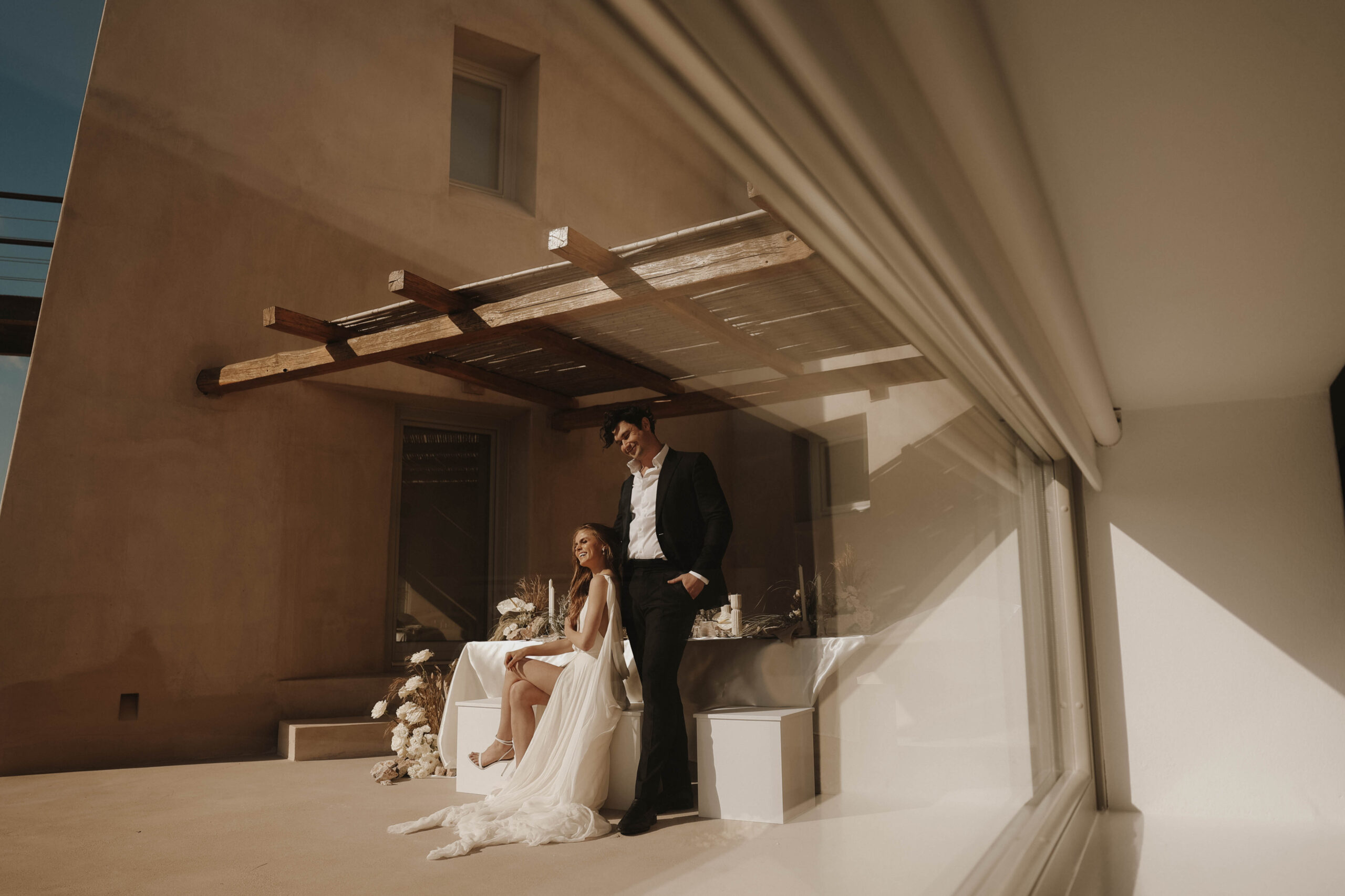 bride and groom sitting at Santorini Greece elopement reception table 