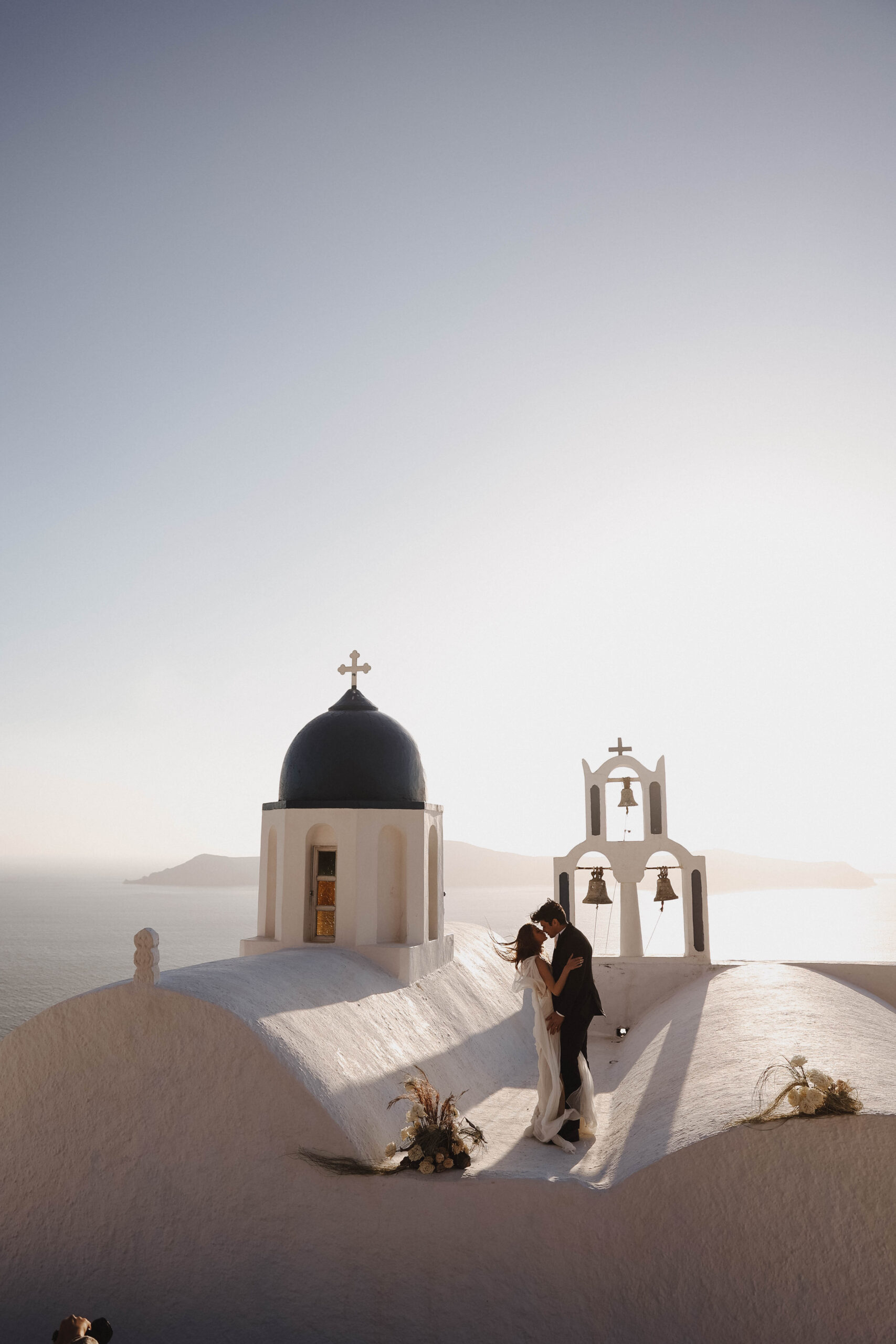bride and groom about to kiss on a roof during their Santorini Greece elopement
