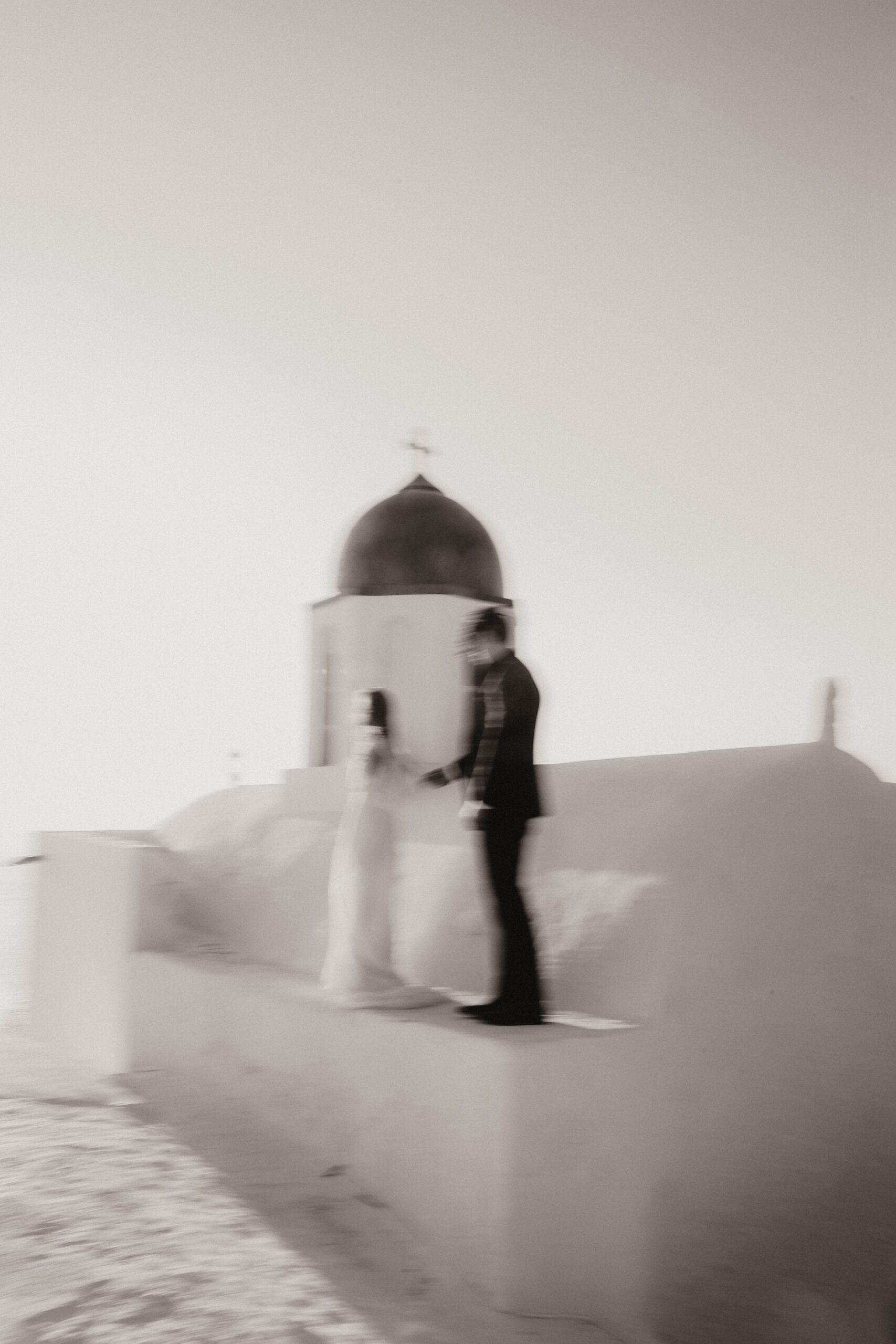 blurry bride and groom on a roof during their Santorini Greece elopement