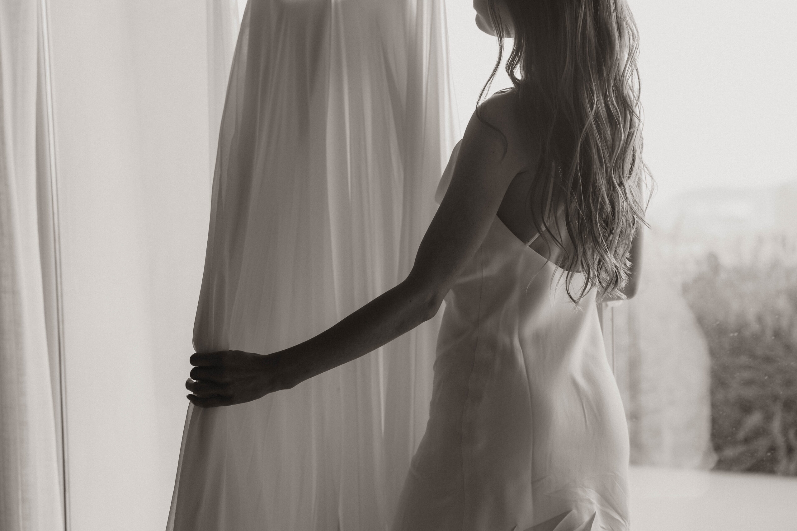 bride holding her Santorini Greece elopement dress