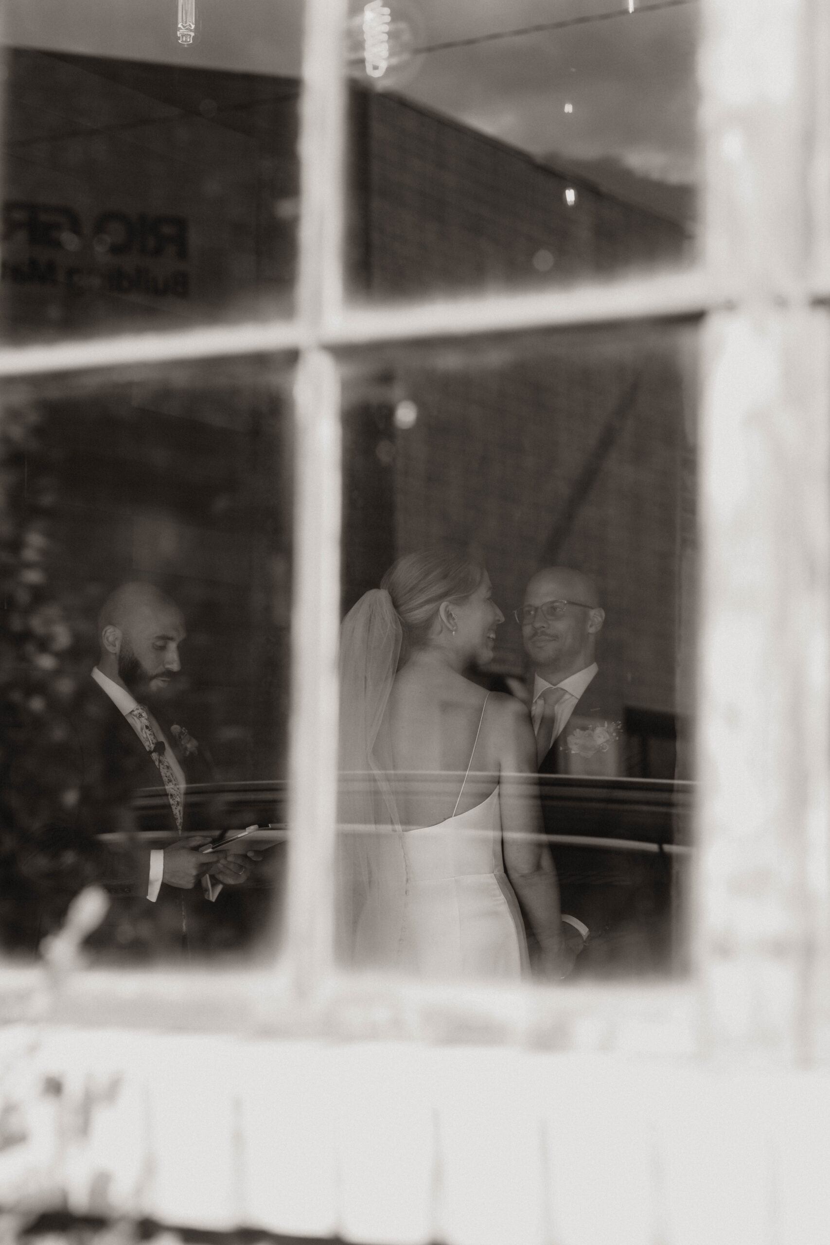 bride and groom through a window 