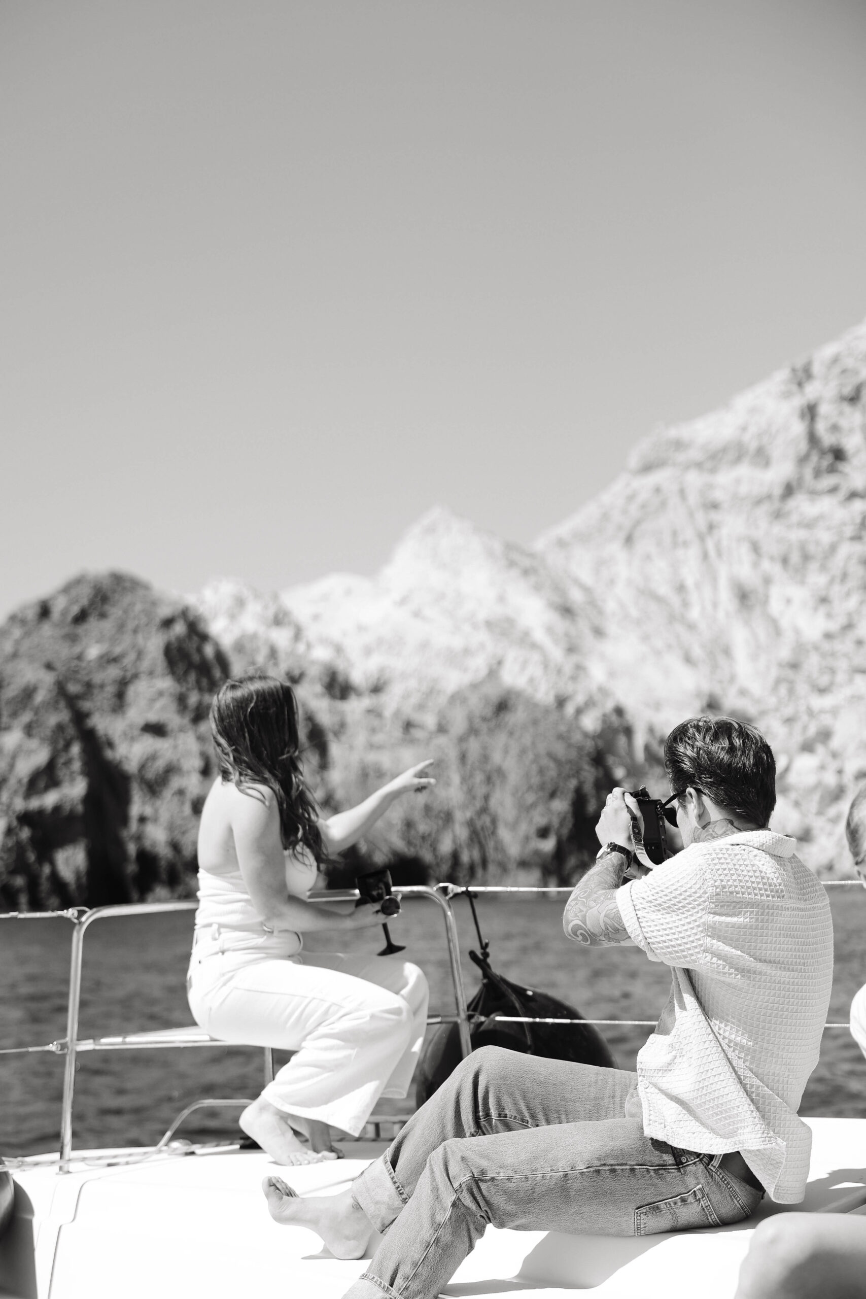 a couple on a sailboat looking at the view together 