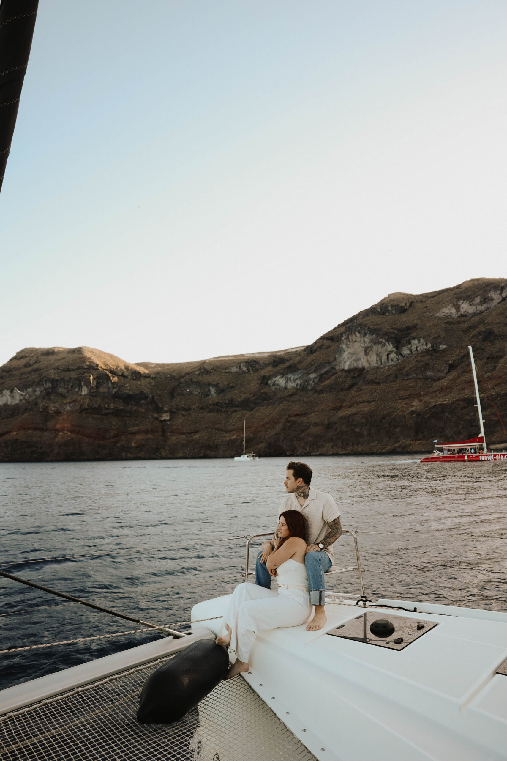 a couple sitting together on a boat during their couples session