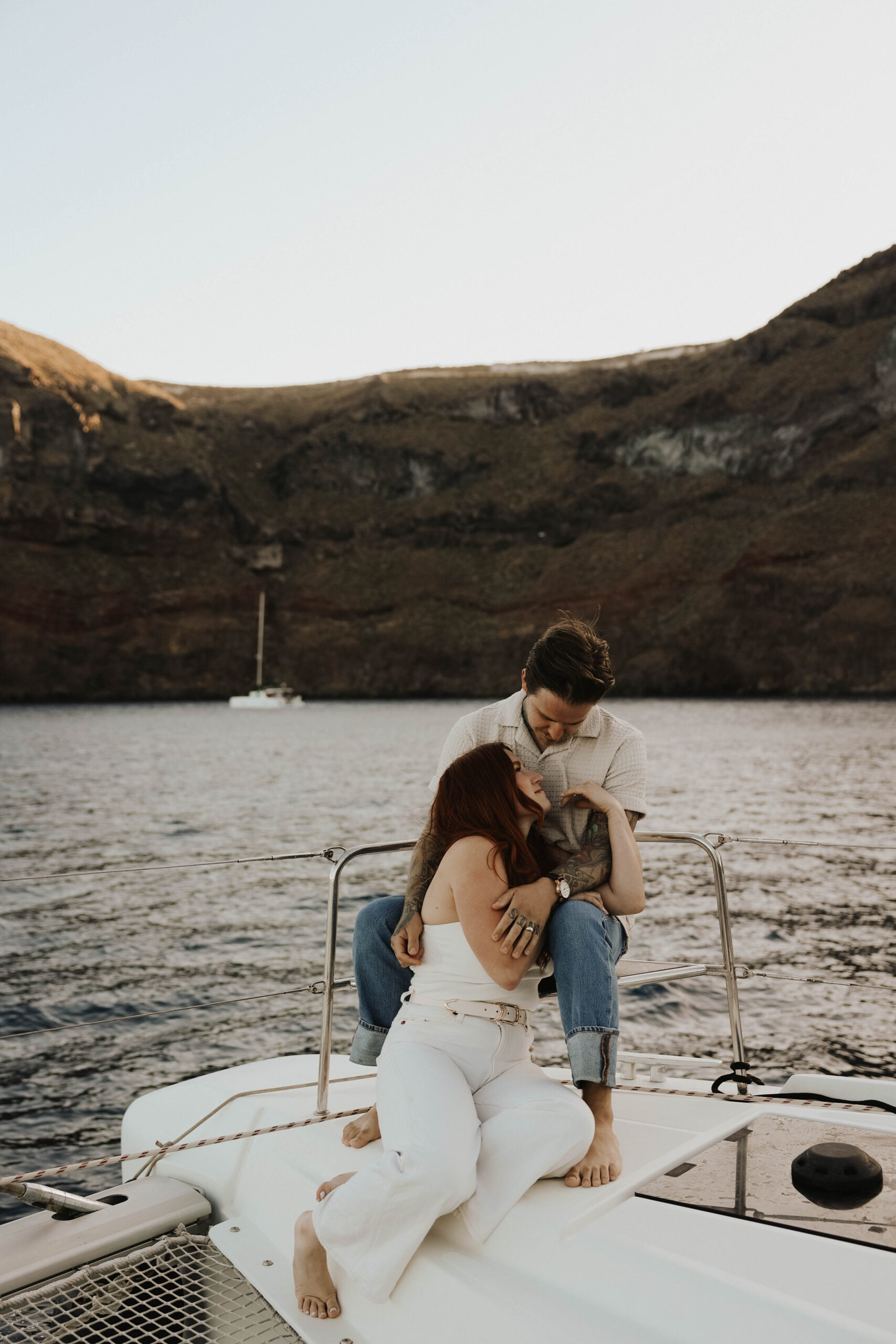 a couple sitting on a sailboat together during their couples session