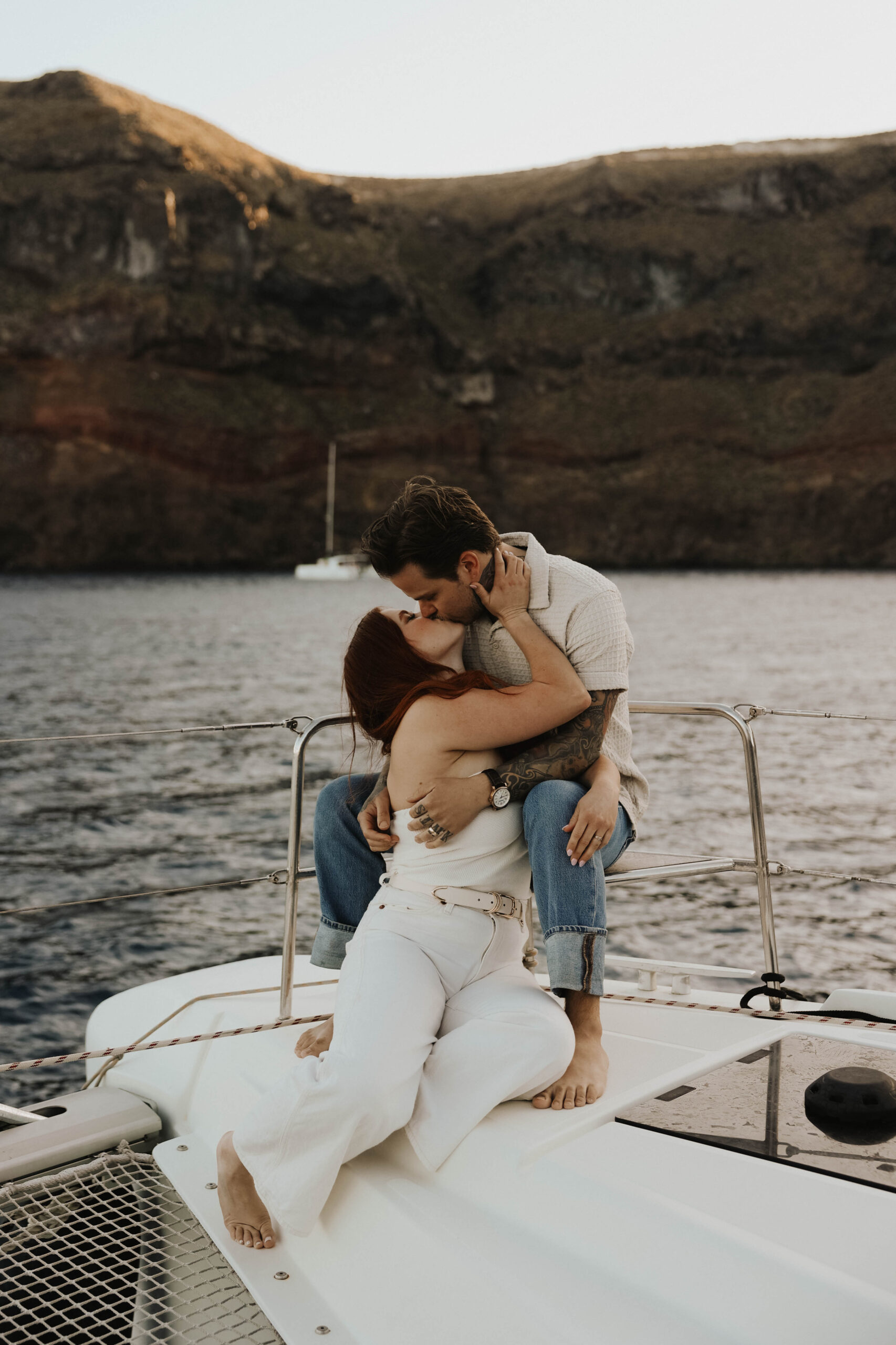 a couple kissing on a sailboat in Greece 