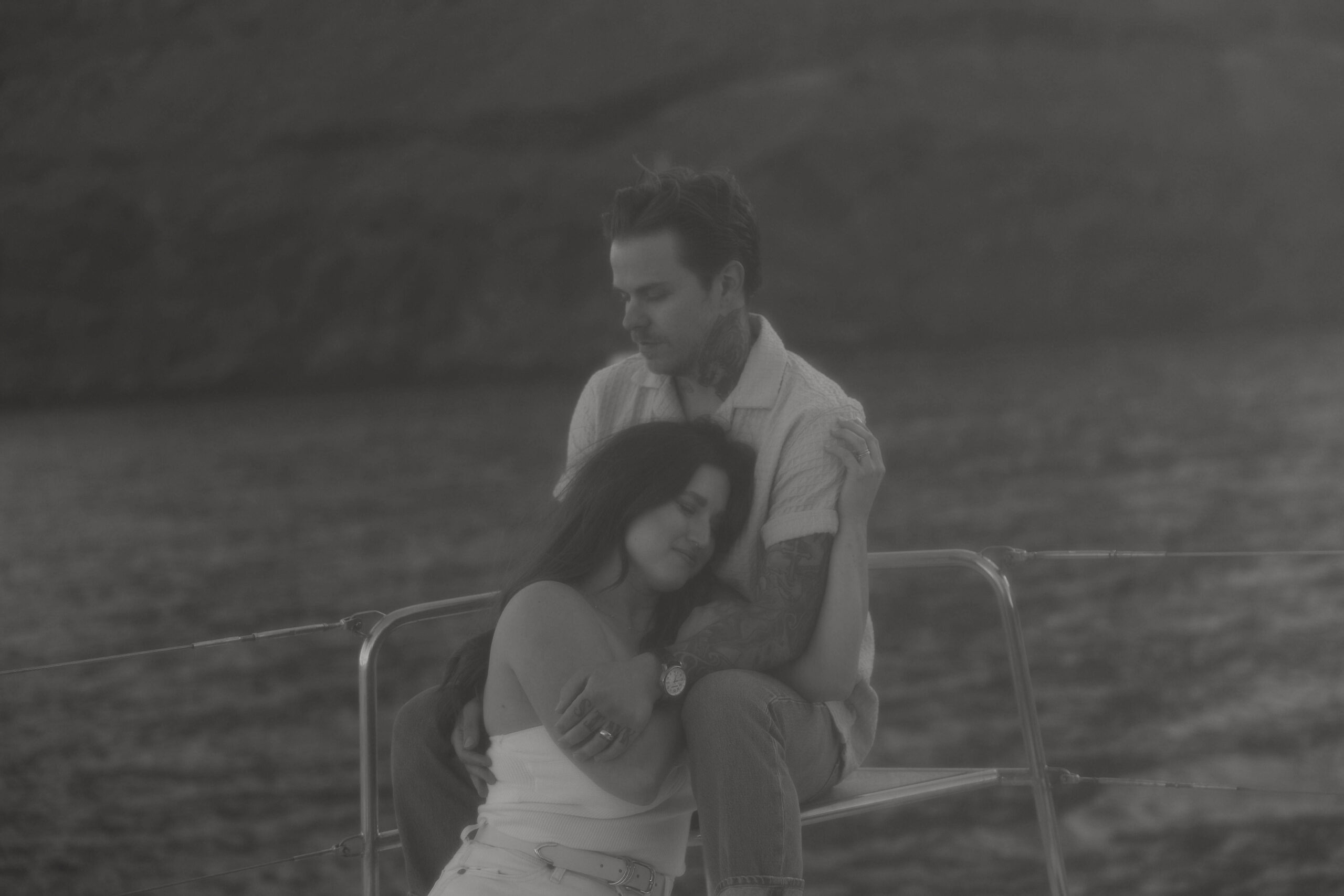 a couple holding each other on a boat during their couples session