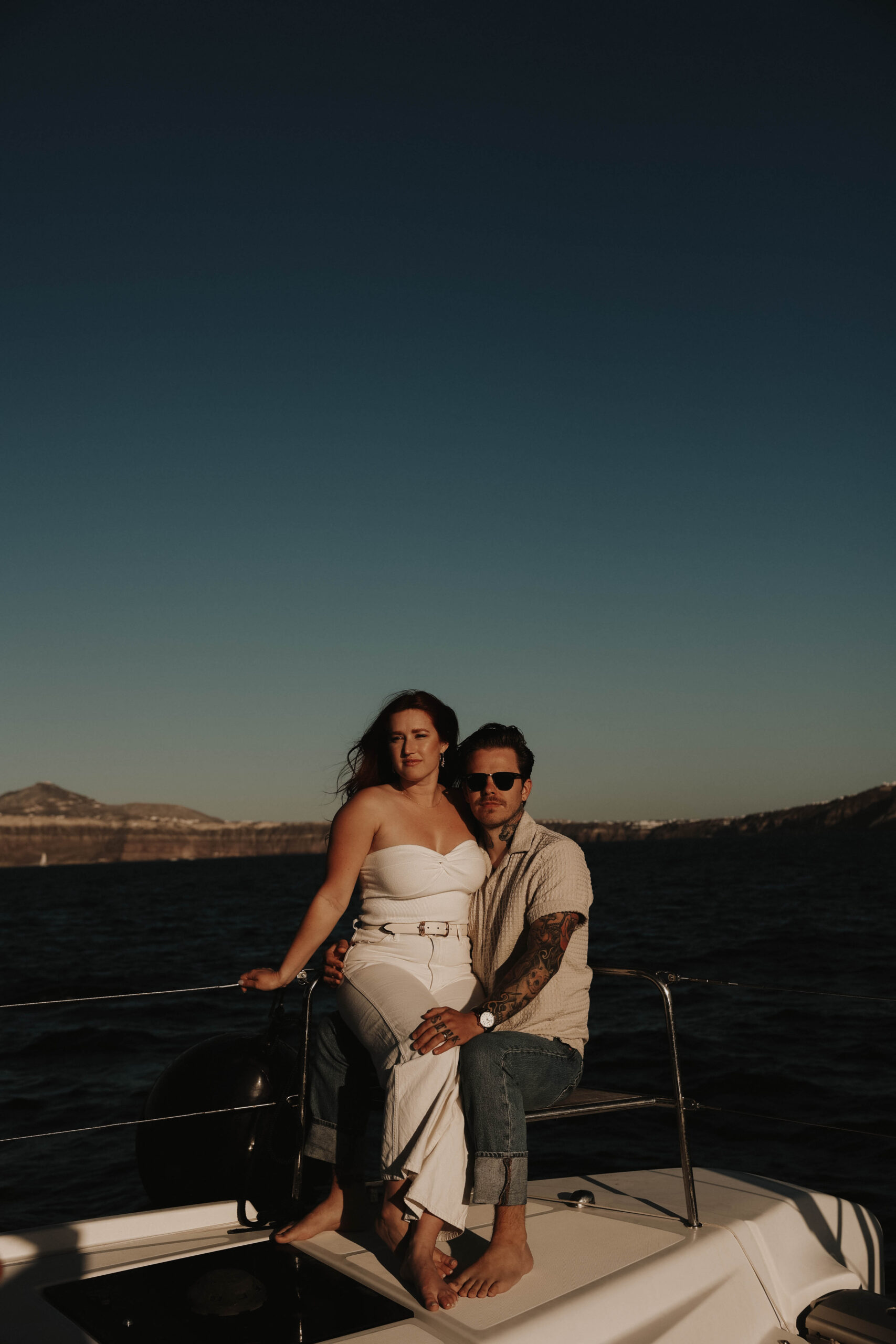 a couple on a boat during golden hour during their couples session