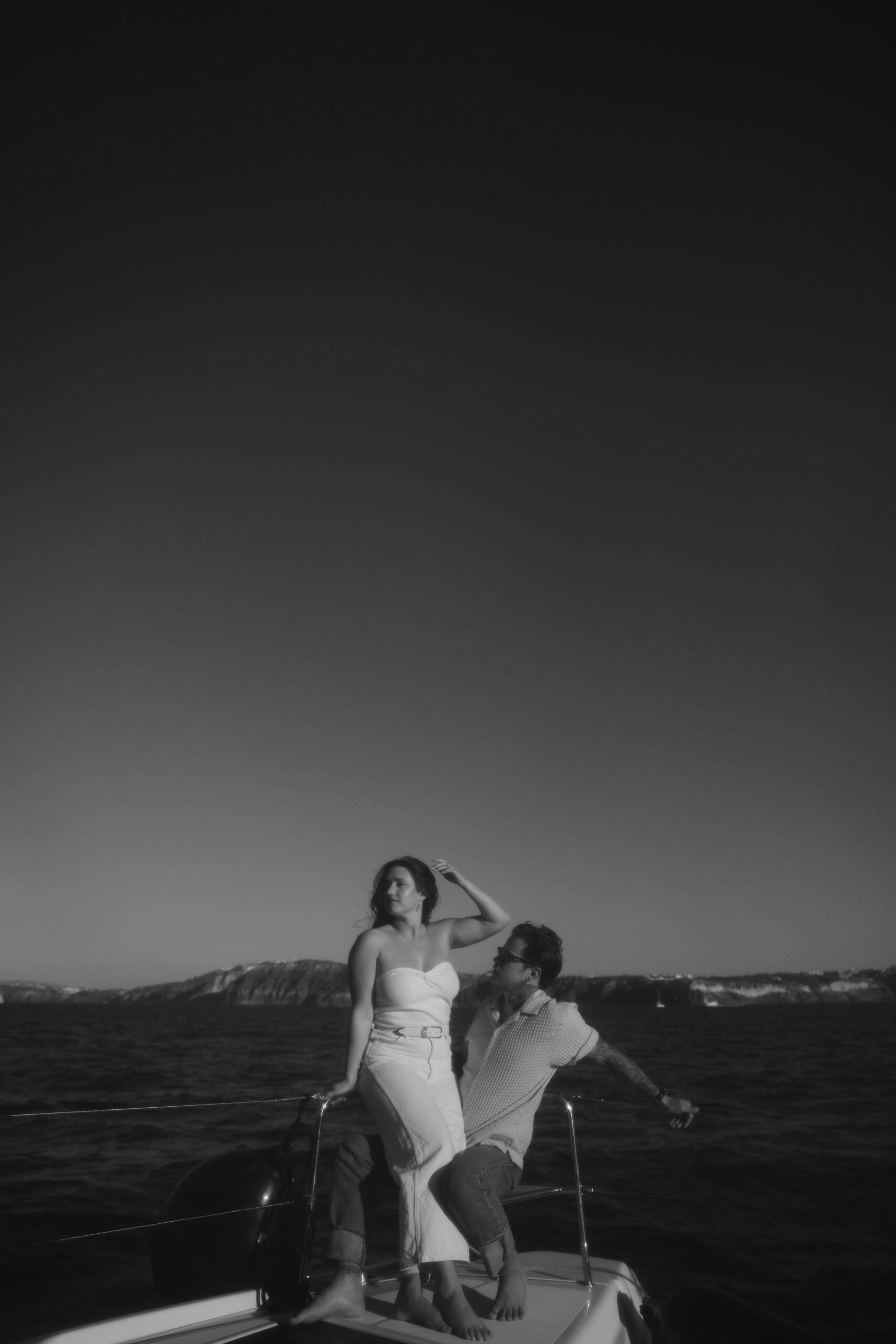 a woman sitting on a mans lap during their couples session