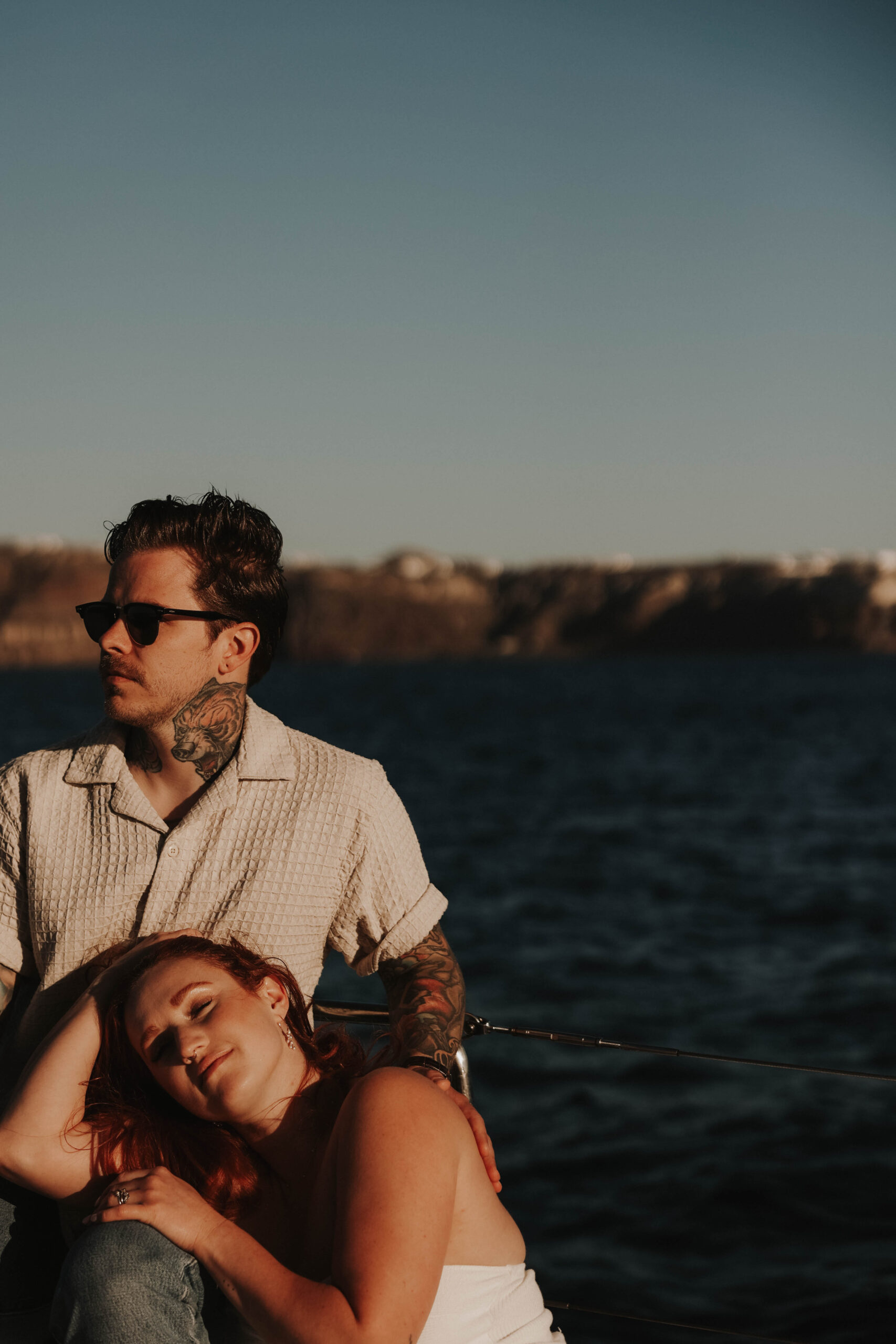 a woman resting her head on a man's legs during their couples session