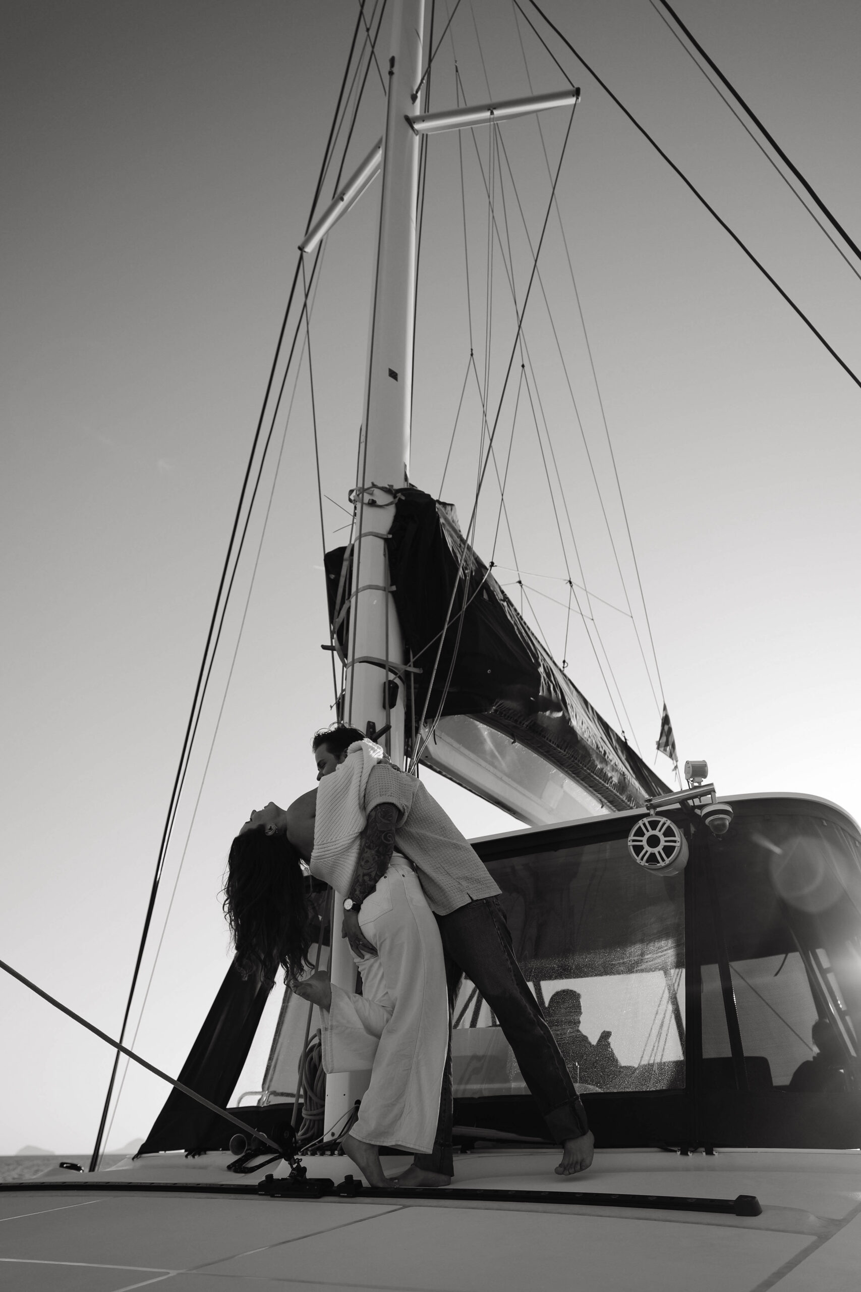 a couple sancing on a sailboat during their couples session