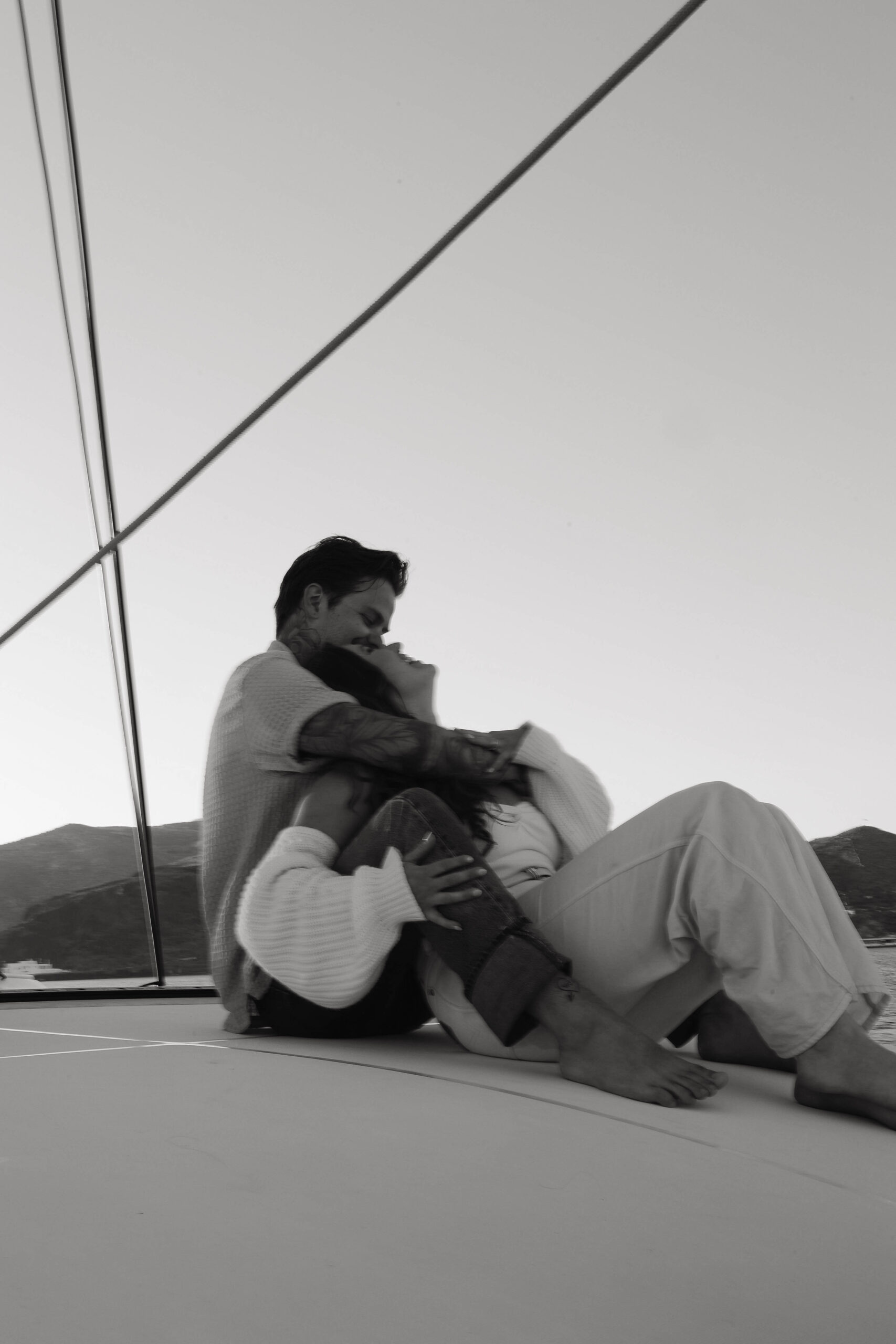 a couple leaning into each other and holding each other on a boat 