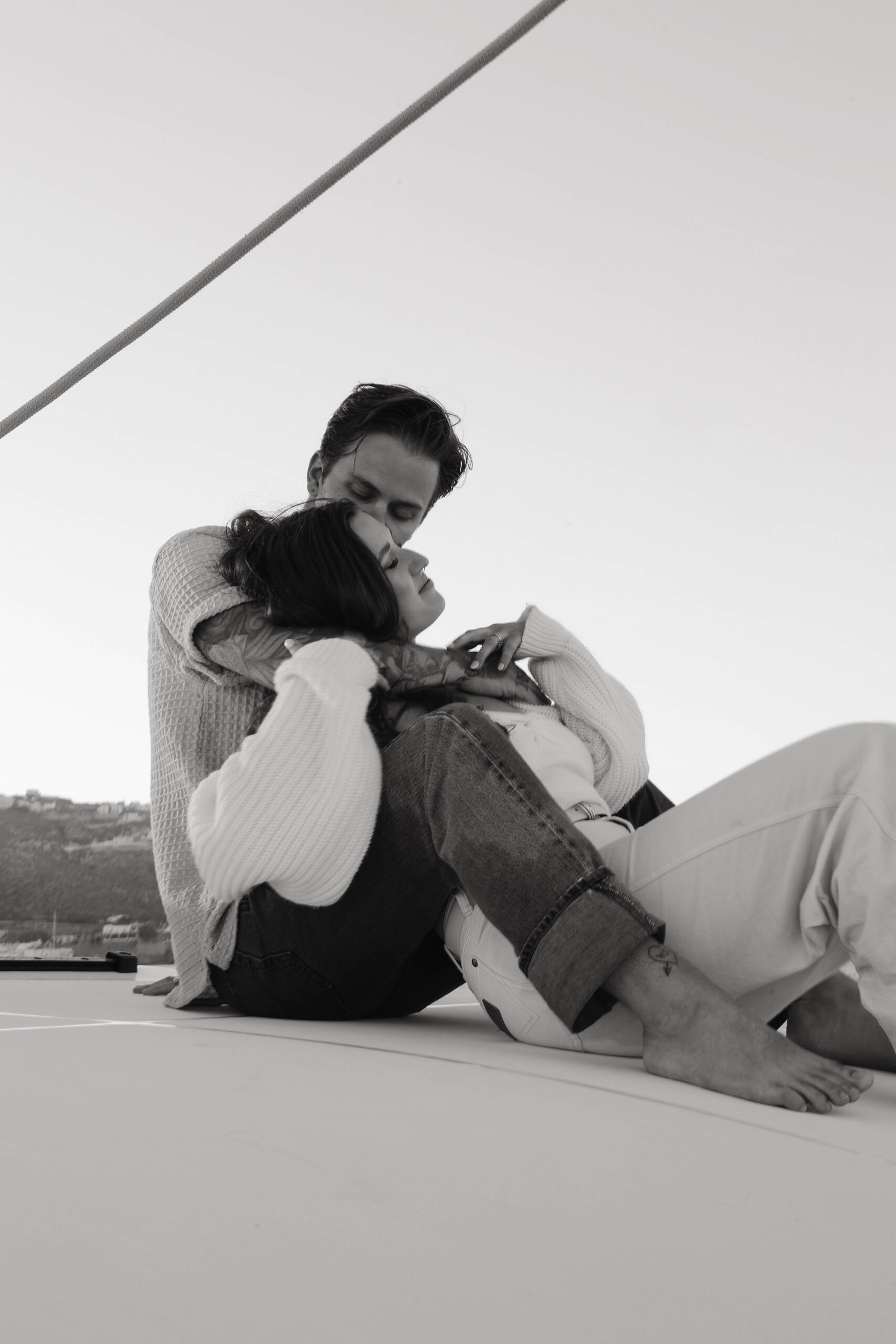 a woman leaning back into a man as he holds her during their couples session