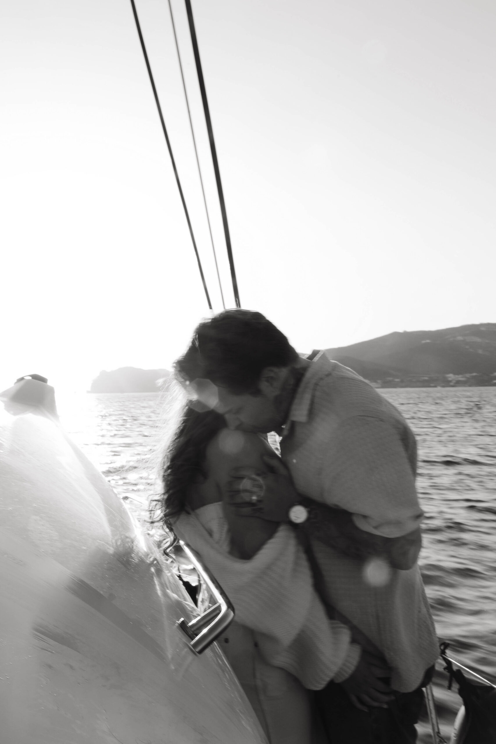 a man kissing a woman's shoulder during their couples session