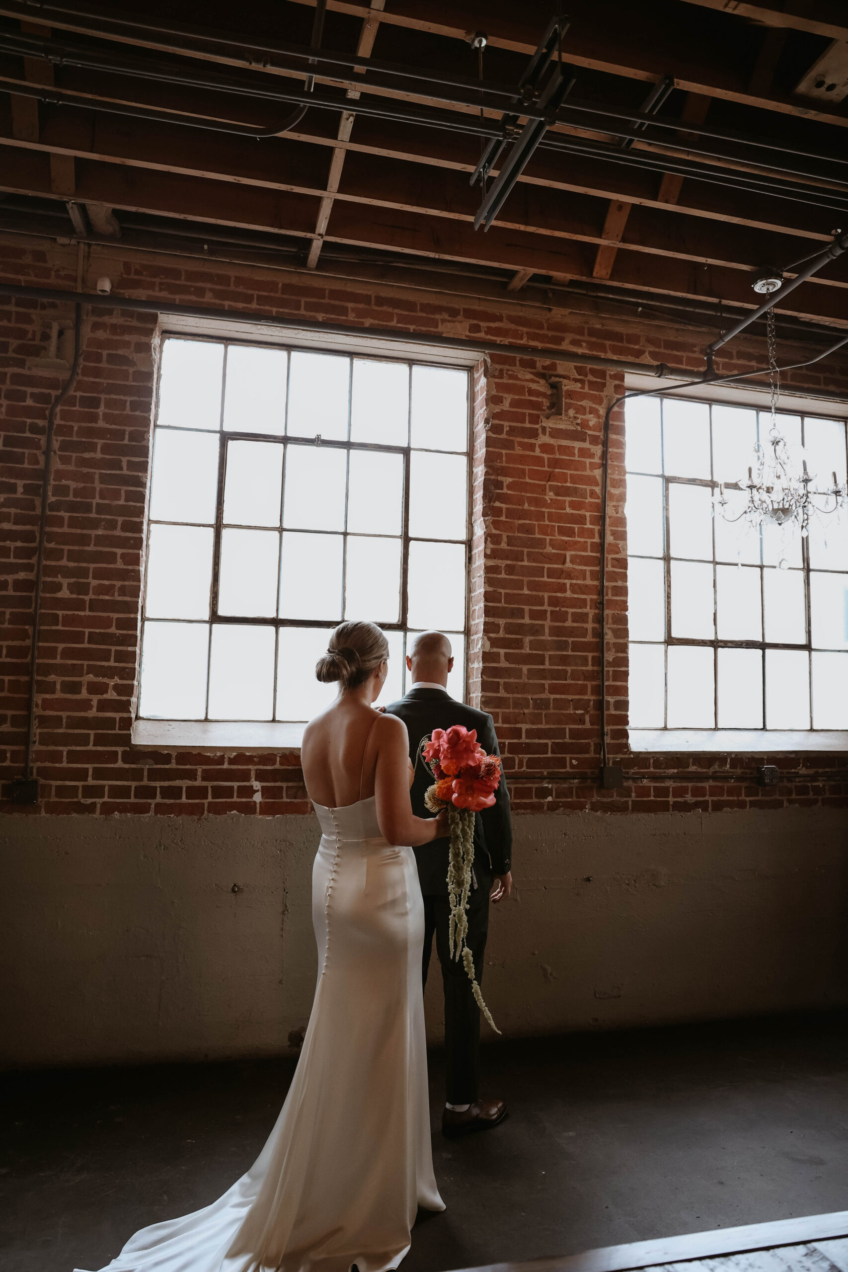 bride standing behind groom for first look at one of the most perfect Denver Colorado venues