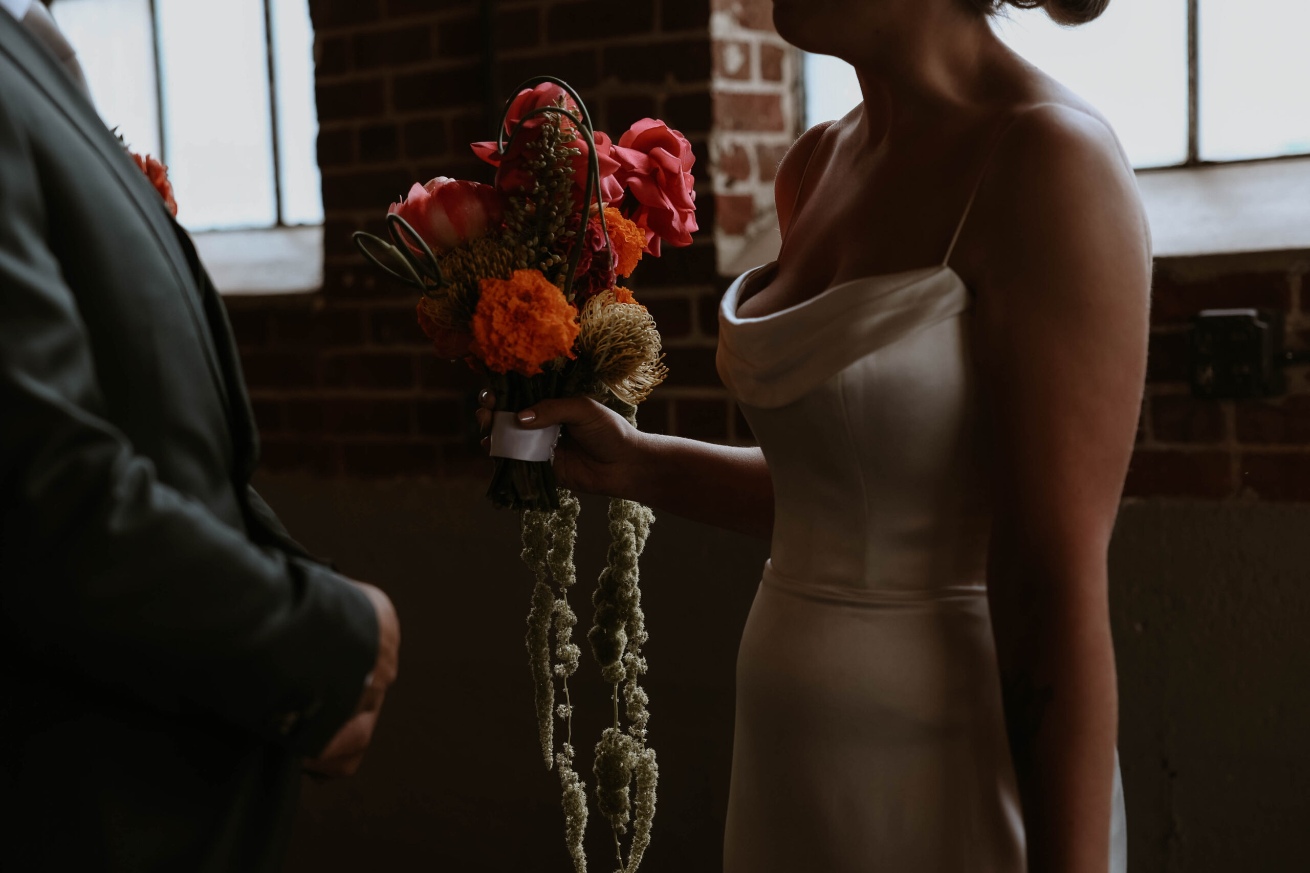 bride holding her colorful bouquet at one of the most perfect Denver Colorado venues