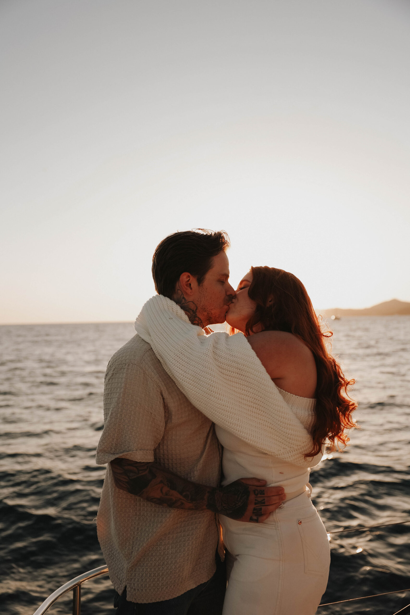 a couple kissing on a boat during their couples session