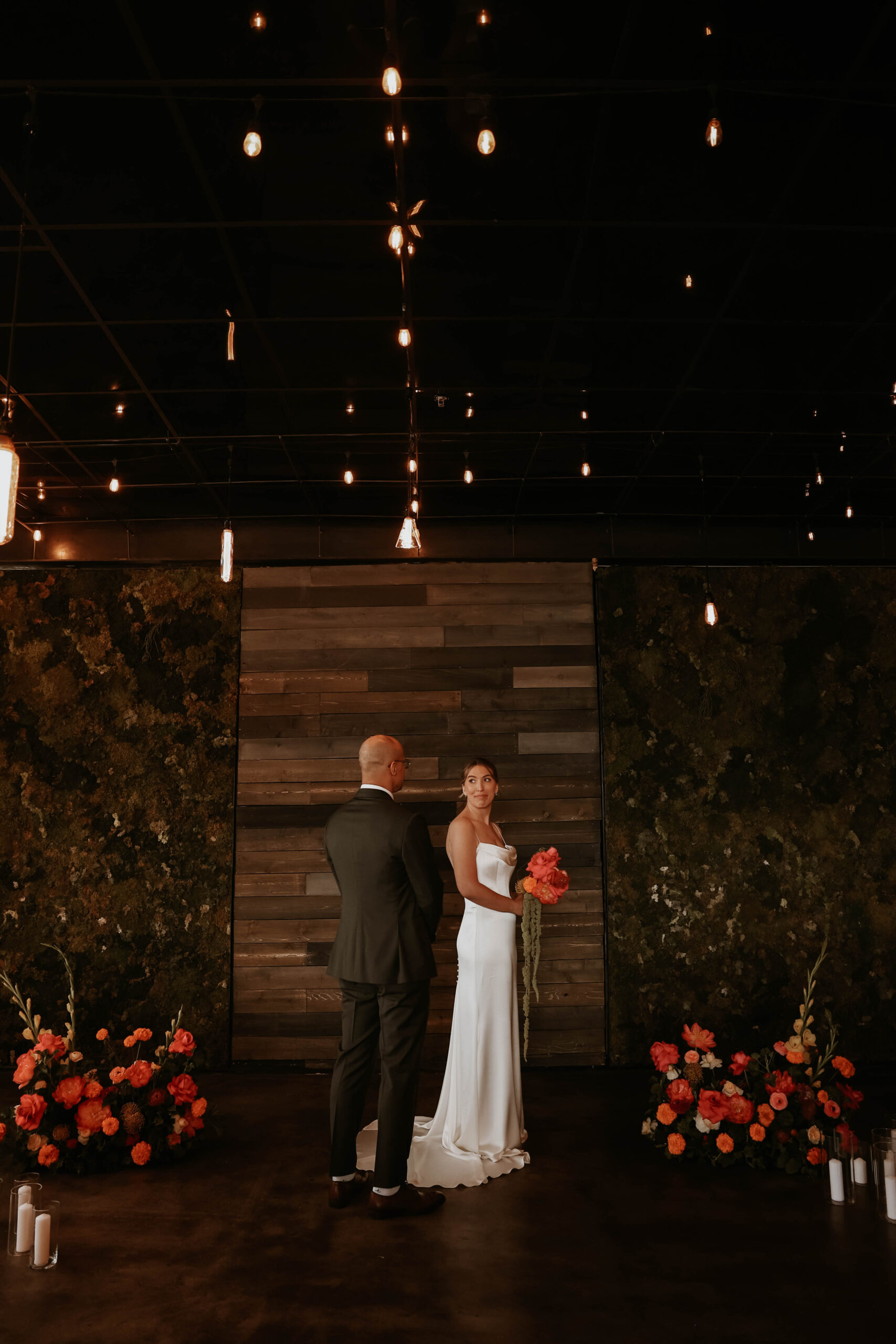 bride and groom portrait at their floral backdrop at one of the most perfect Denver Colorado venues