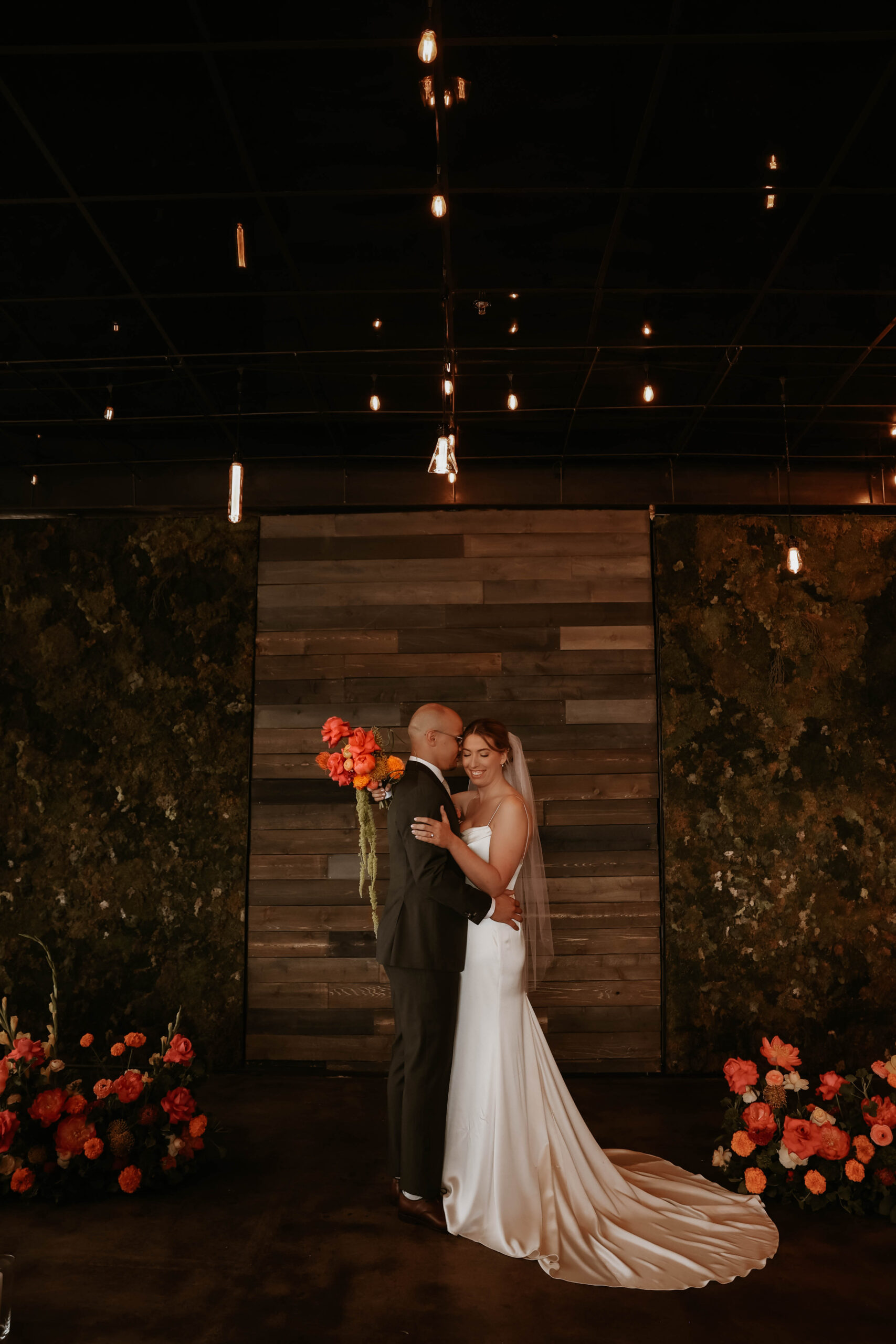 bride and groom portrait at the floral altar at one of the most perfect Denver Colorado venues