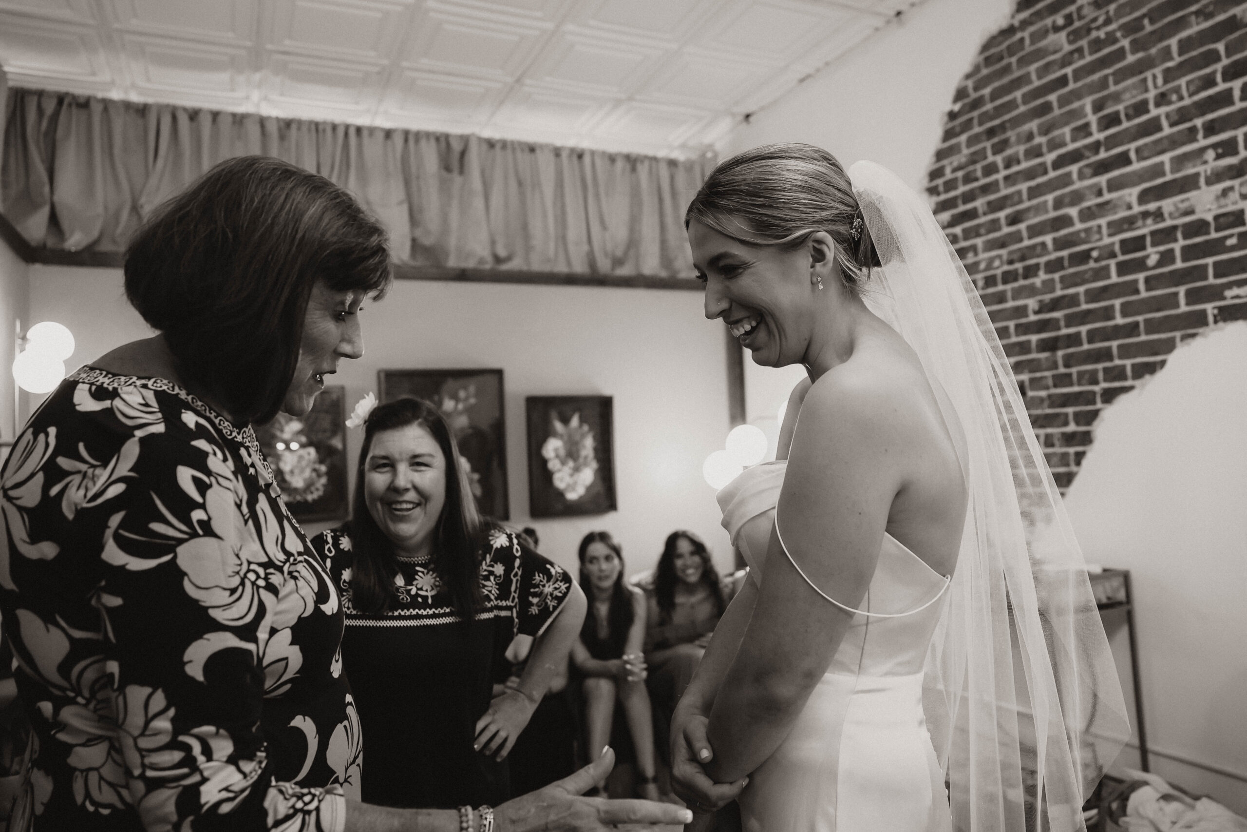 bride laughing with family before wedding 