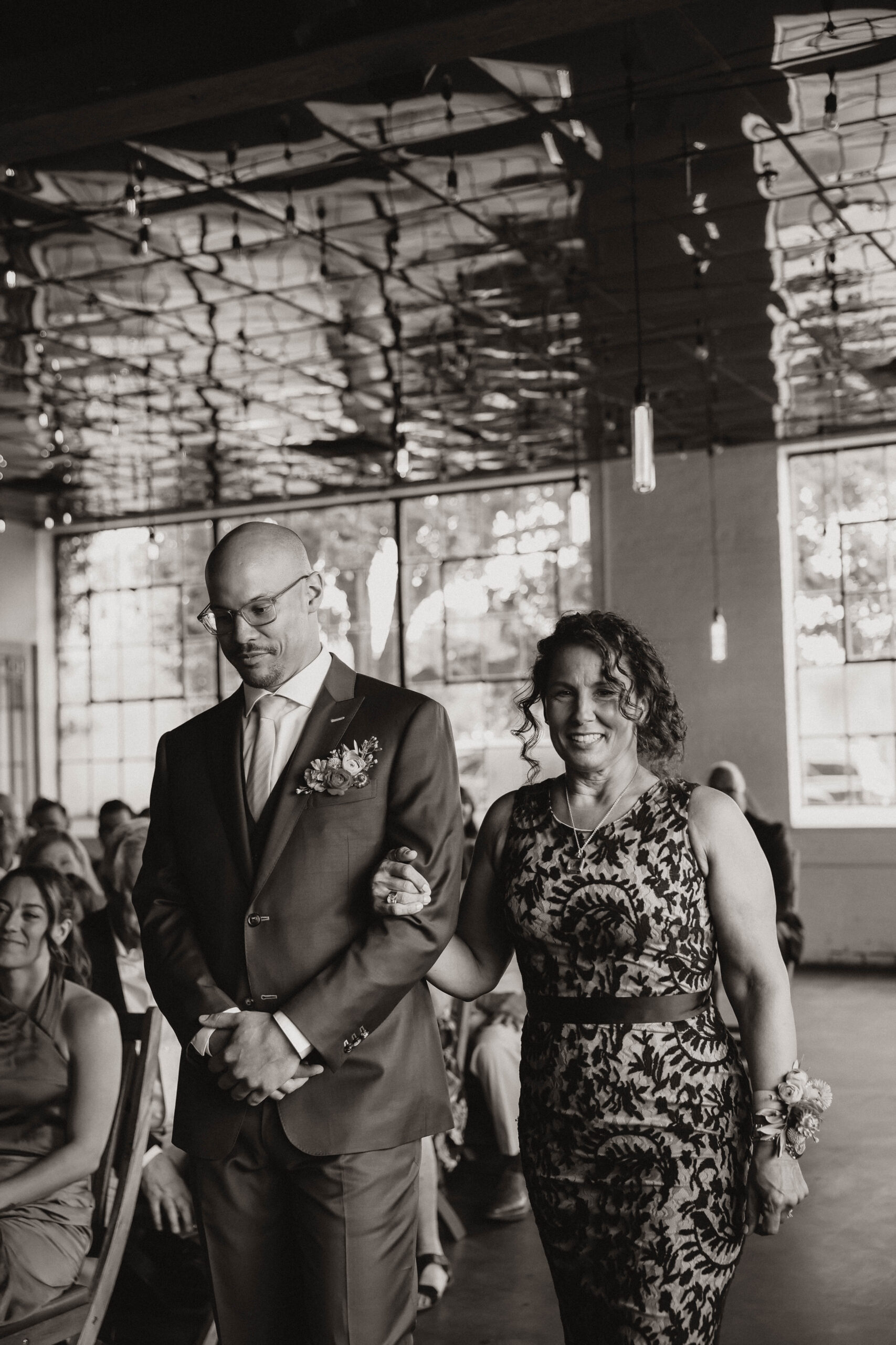 groom and his mother walking down the aisle at one of the most perfect Denver Colorado venues