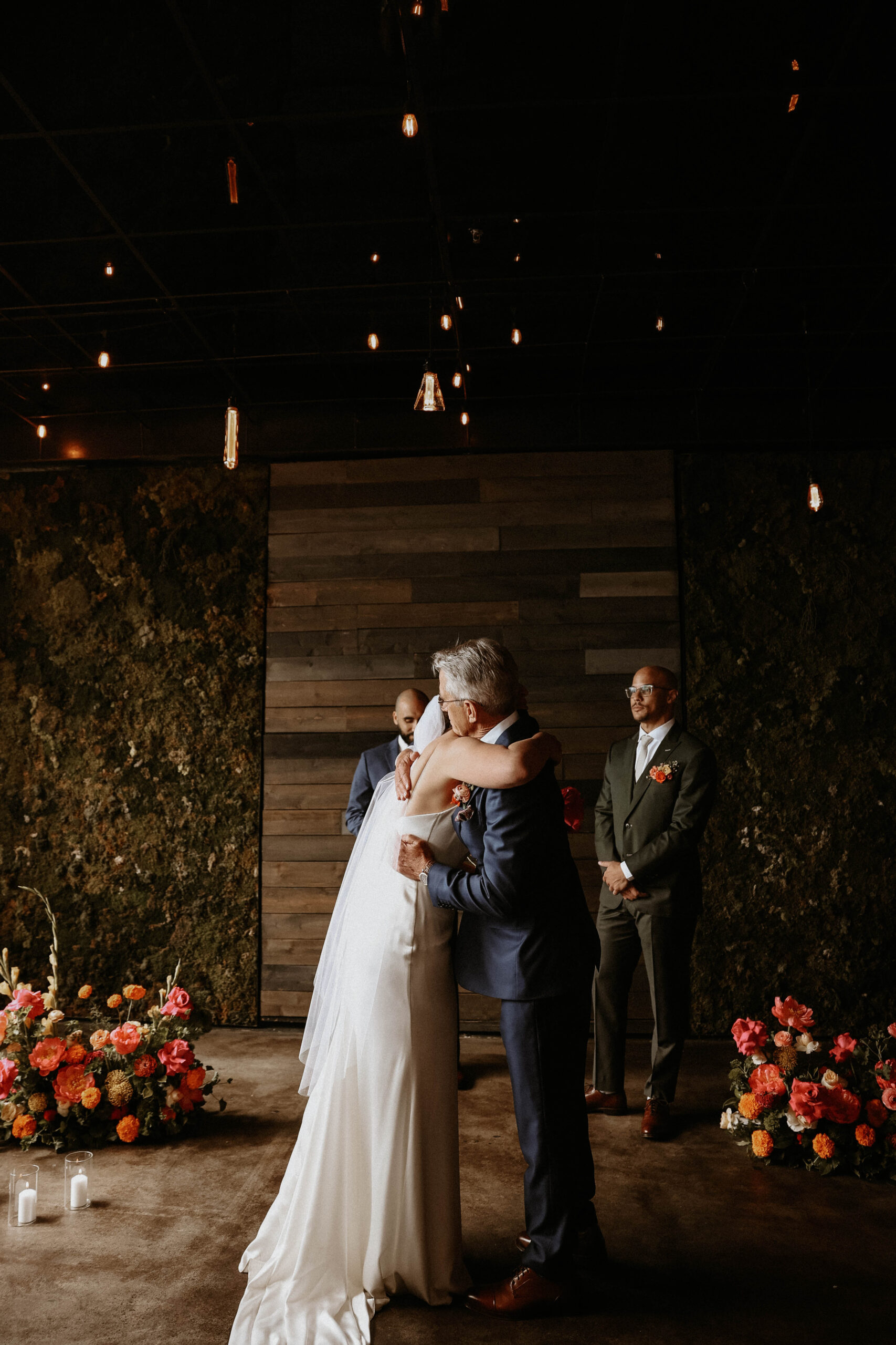 bride hugging her dad at the end of the aisle 