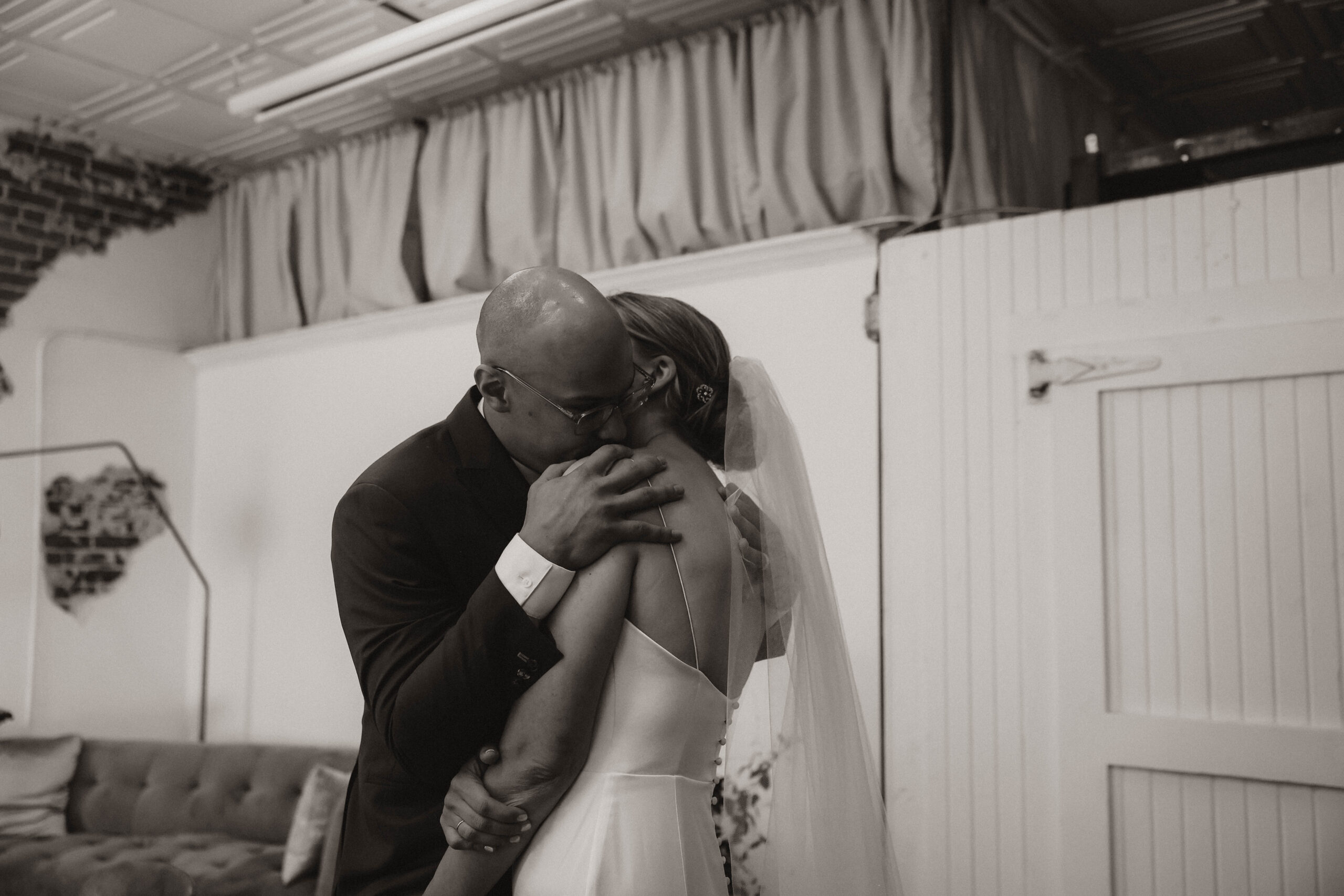 candid of bride and groom hugging