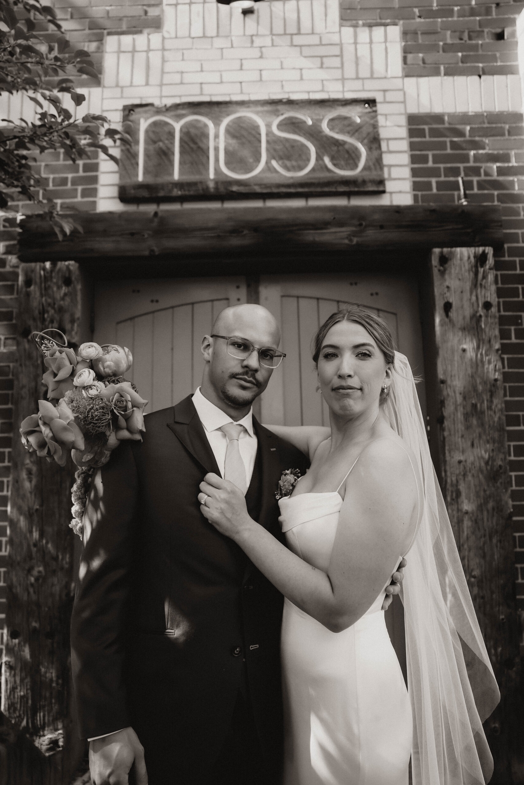 bride and groom portrait in front of Moss Denver 