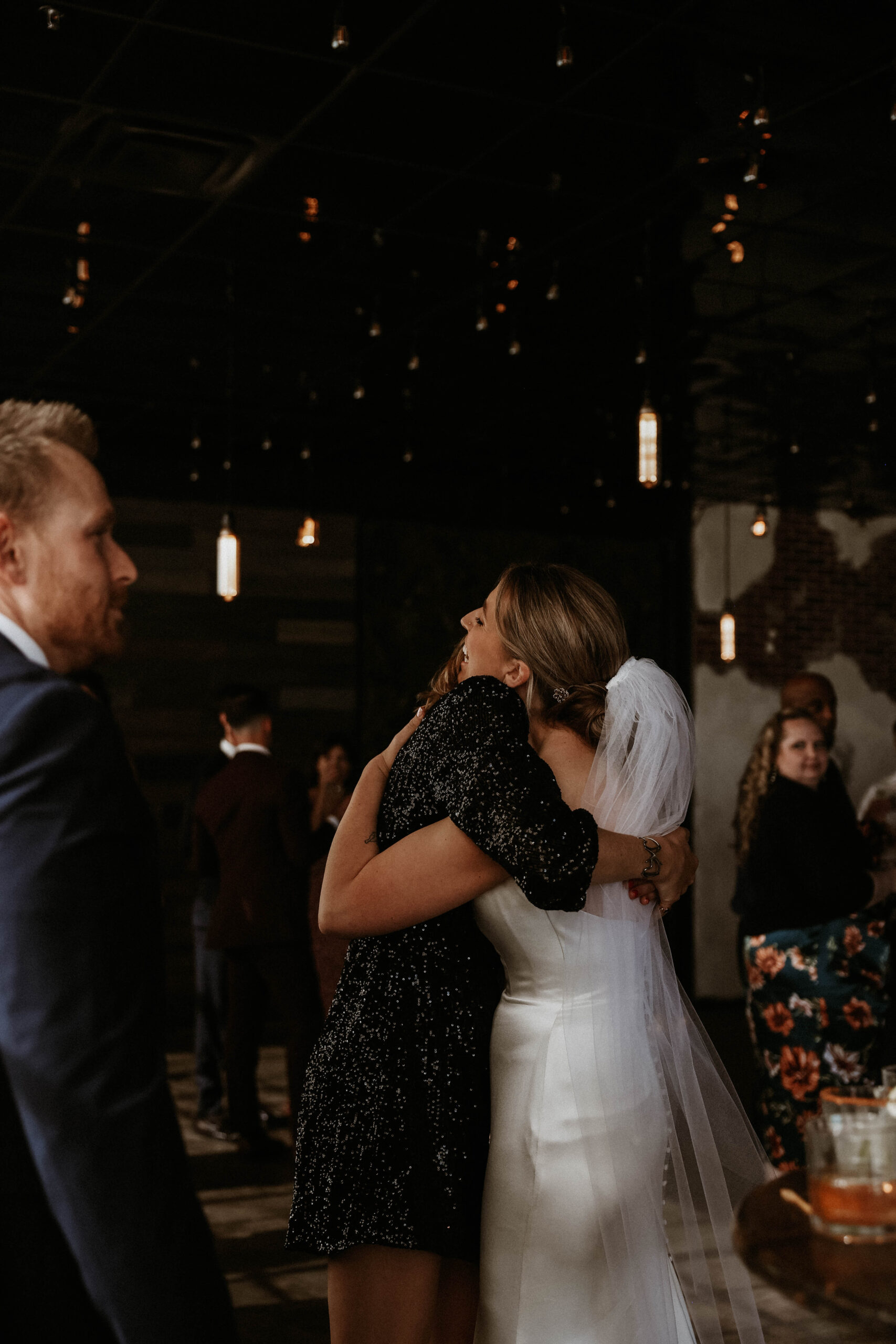 bride hugging a guest at one of the most perfect Denver Colorado venues