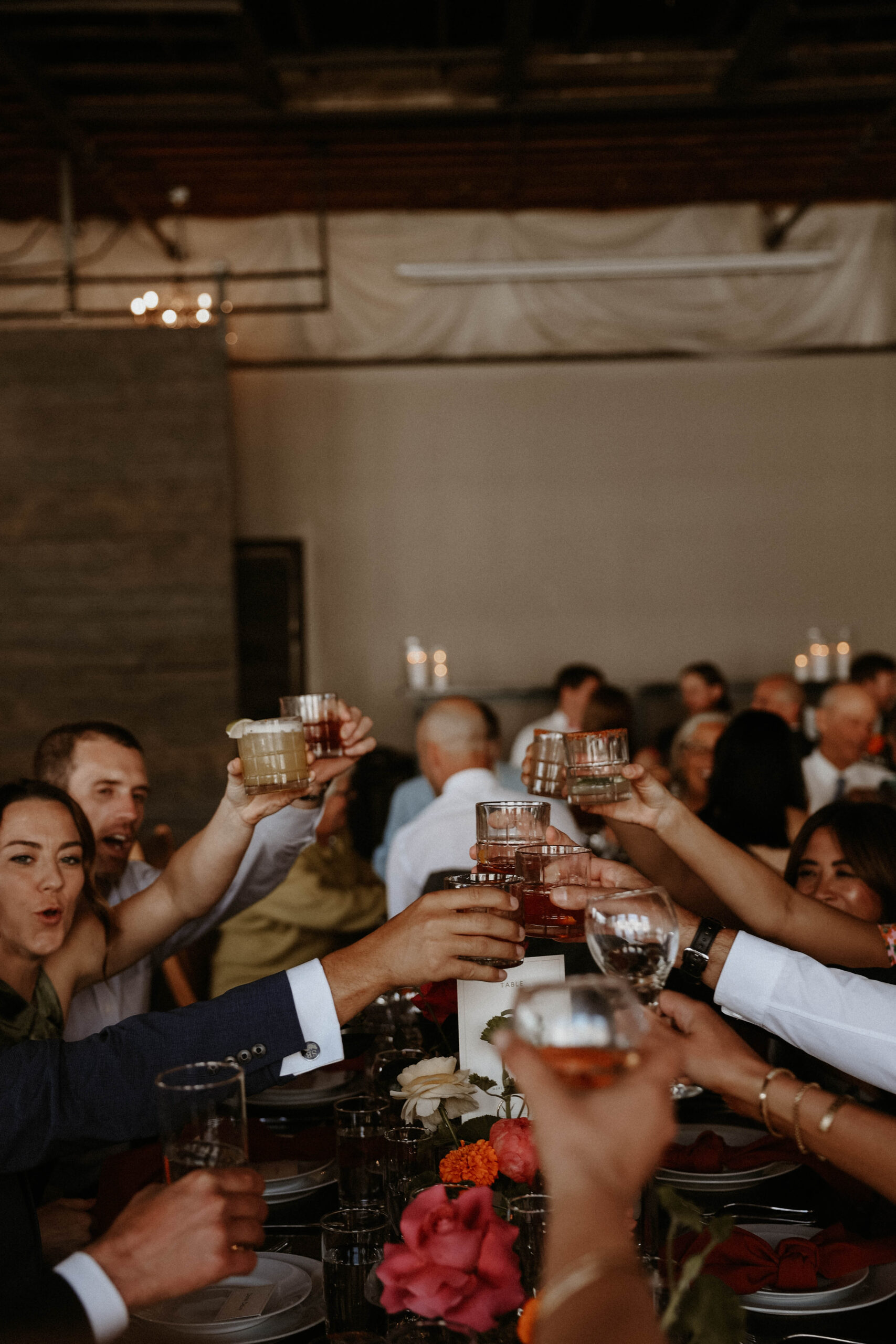 guests raising their glassing during cocktail hour at one of the most perfect Denver Colorado venues