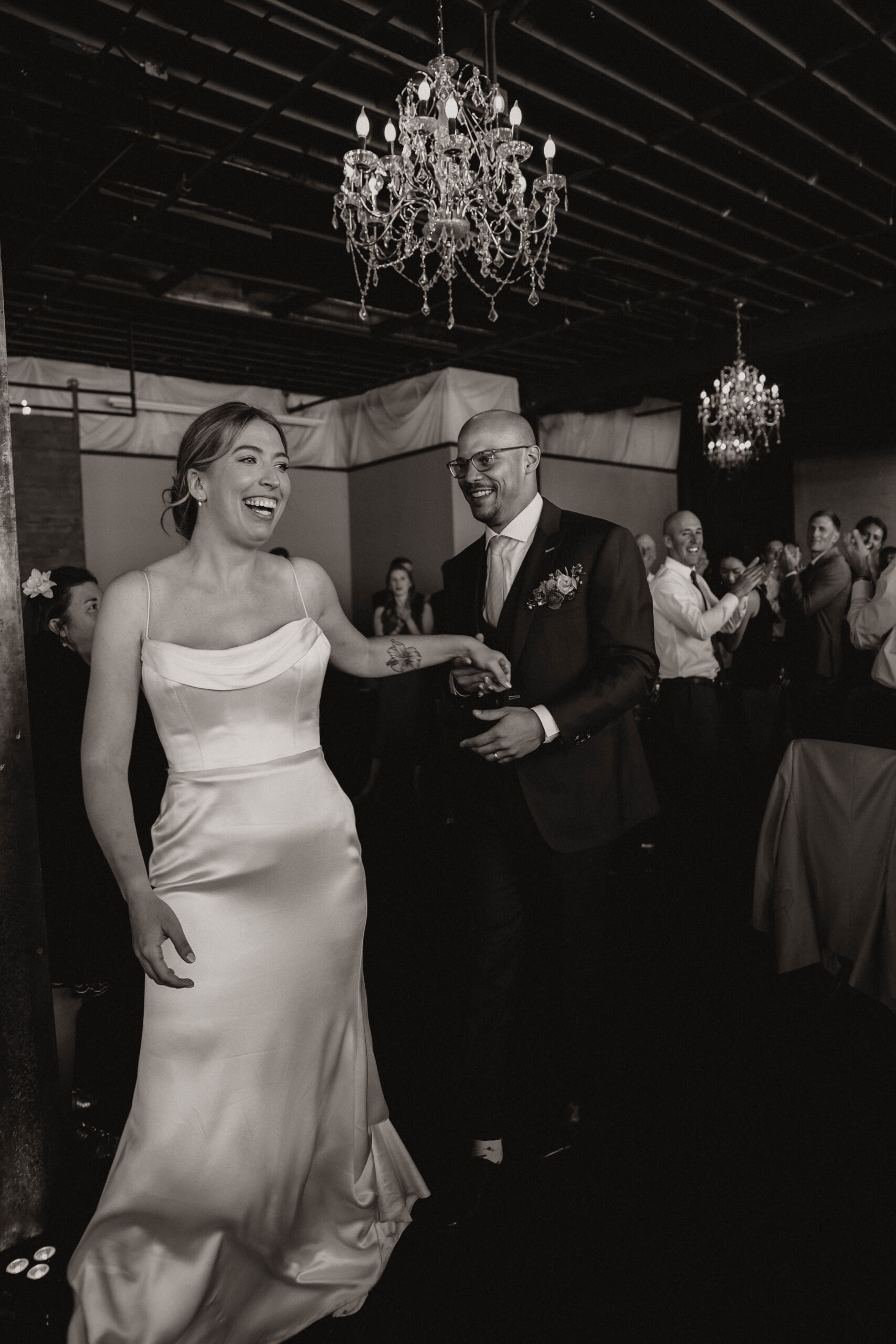 bride and groom walking onto the dance floor 