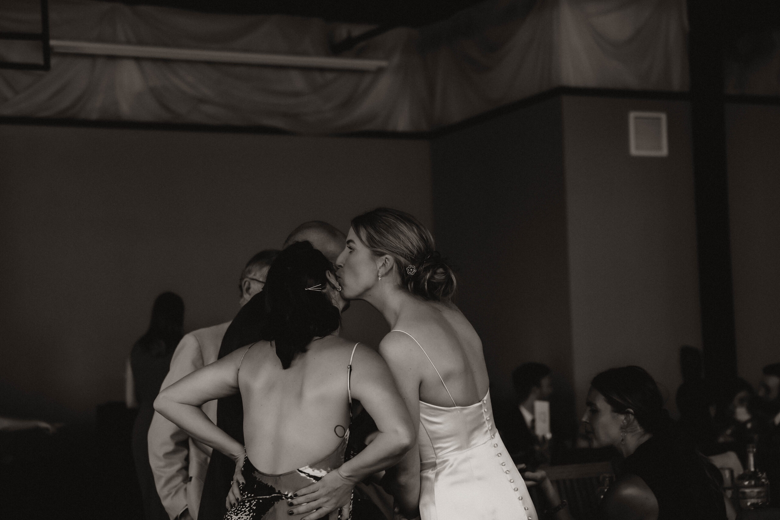 bride kissing friends at cocktail hour 