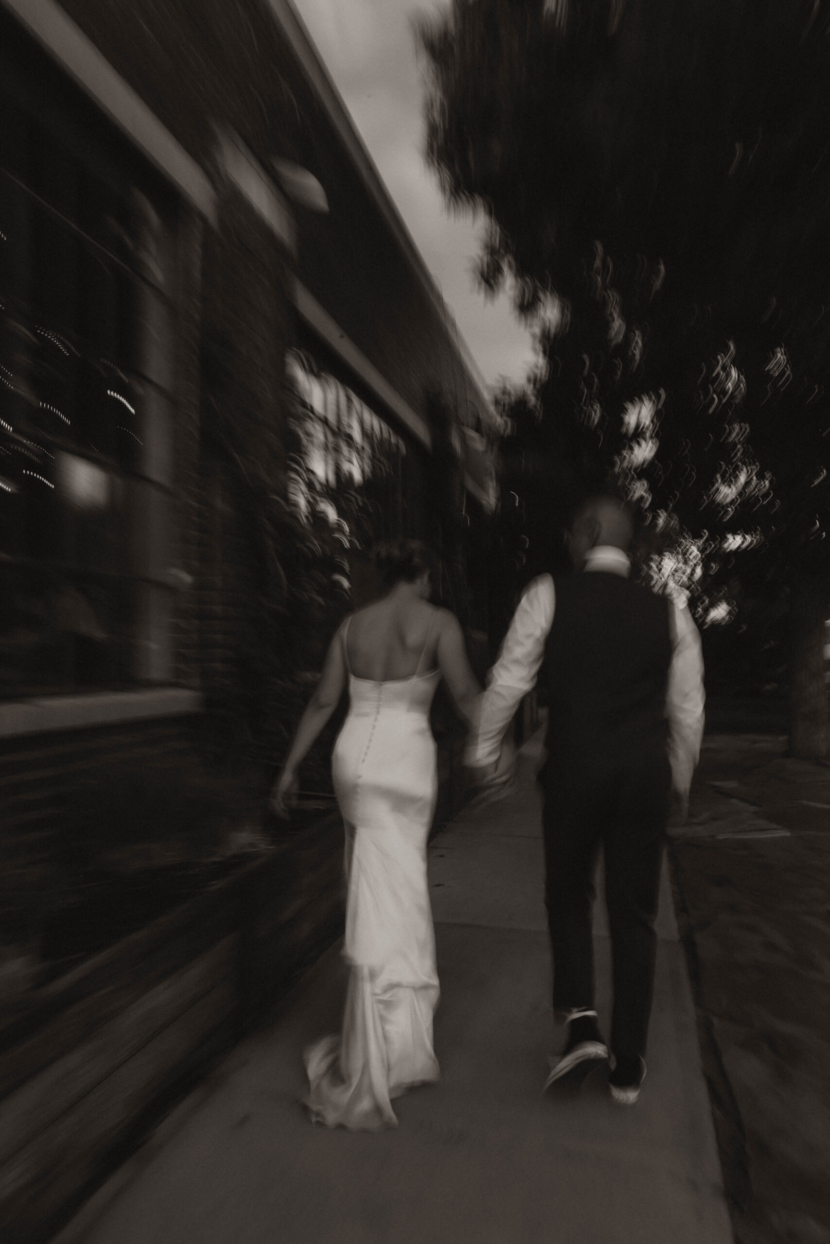 blurry photo of bride and groom walking away 