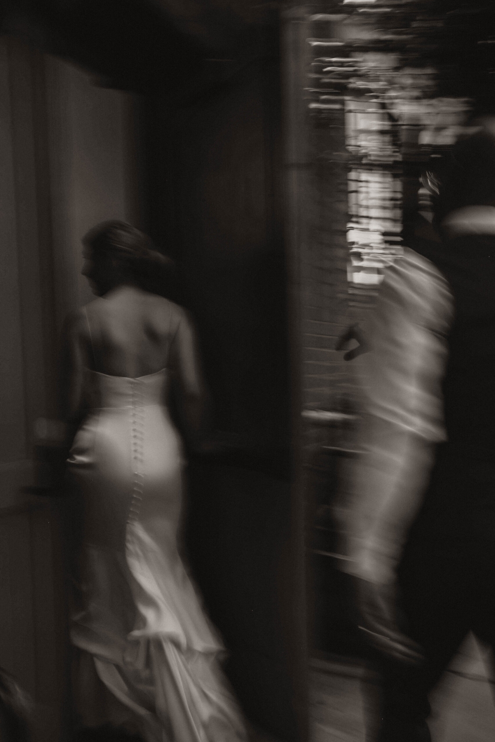 blurry photo of bride and groom walking back into one of the most perfect Denver Colorado venues