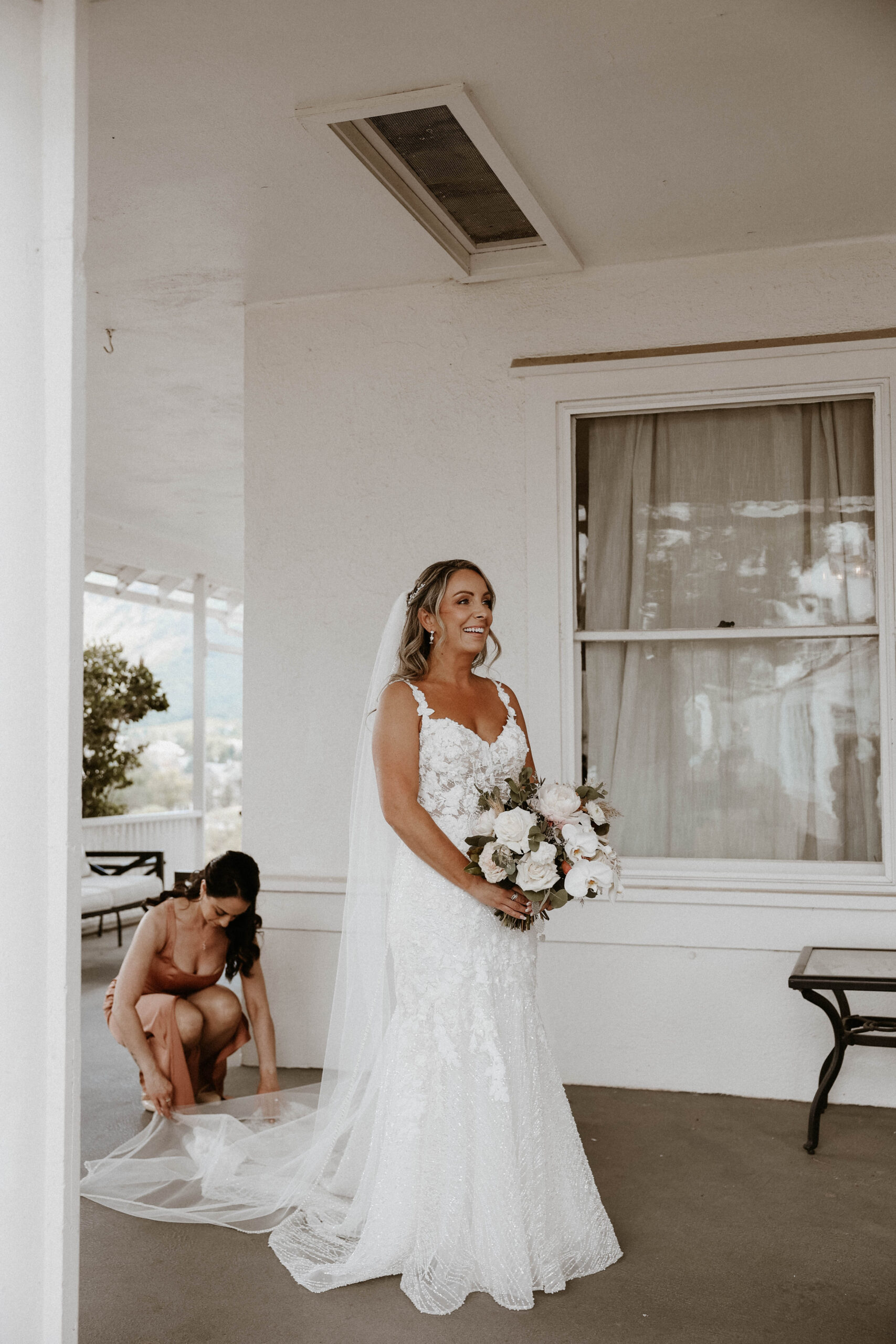 bride getting her dress fixed