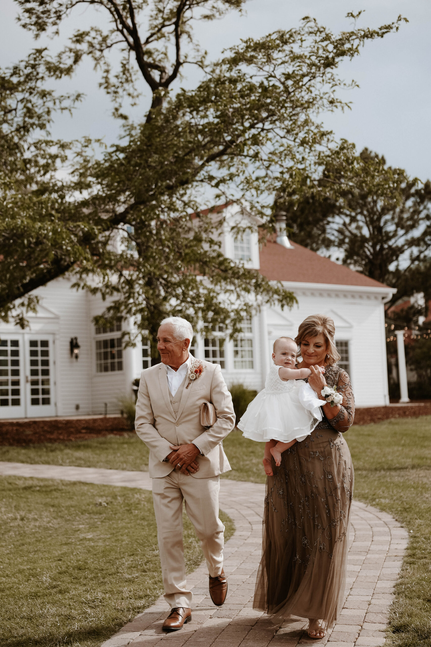 bride's parents walking out with wedding couple's daughter 