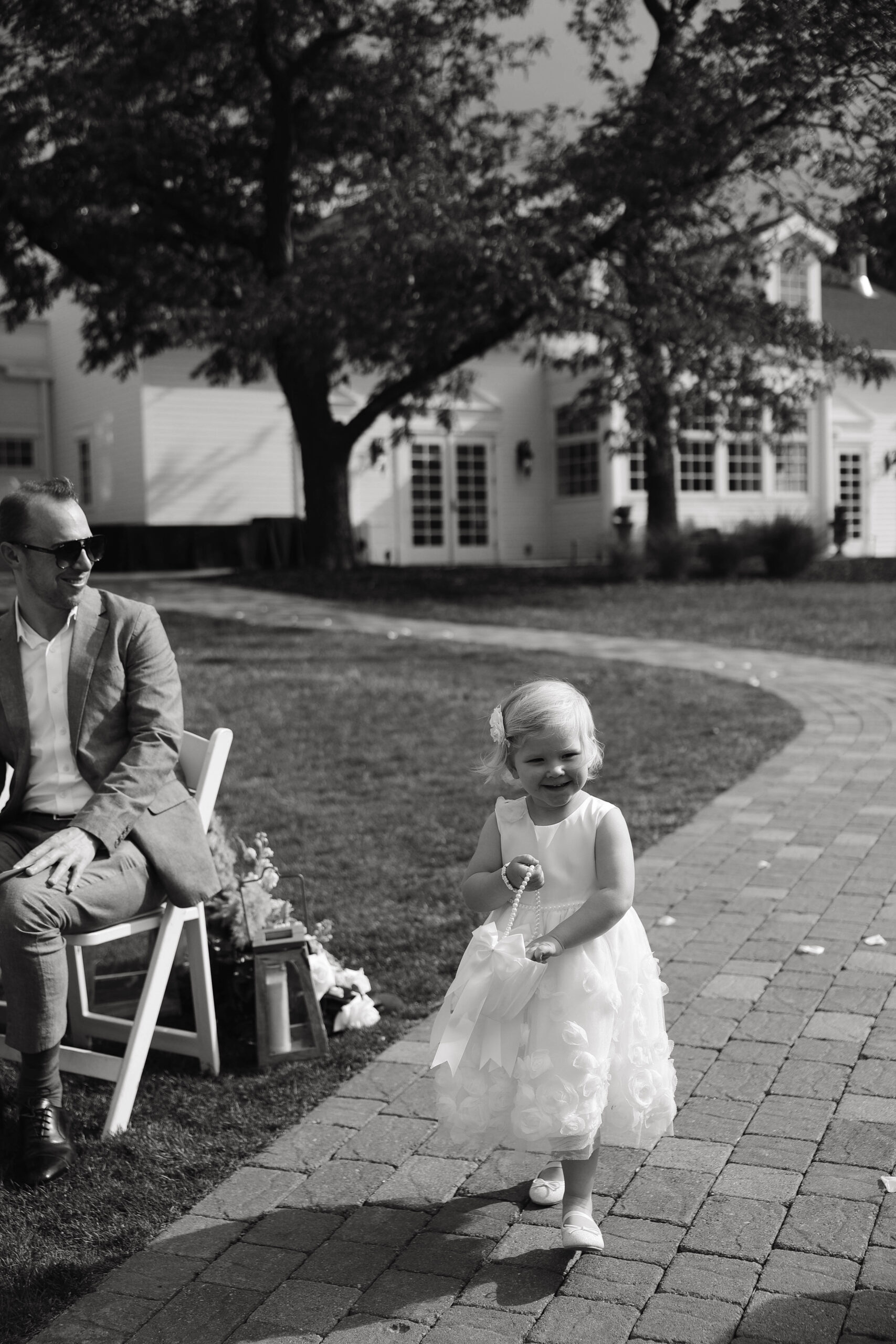 manor house wedding flower girl walking down the aisle 