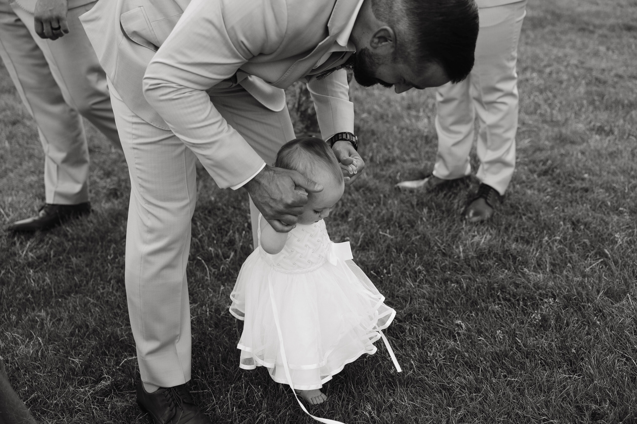 dad helping little girl walk 