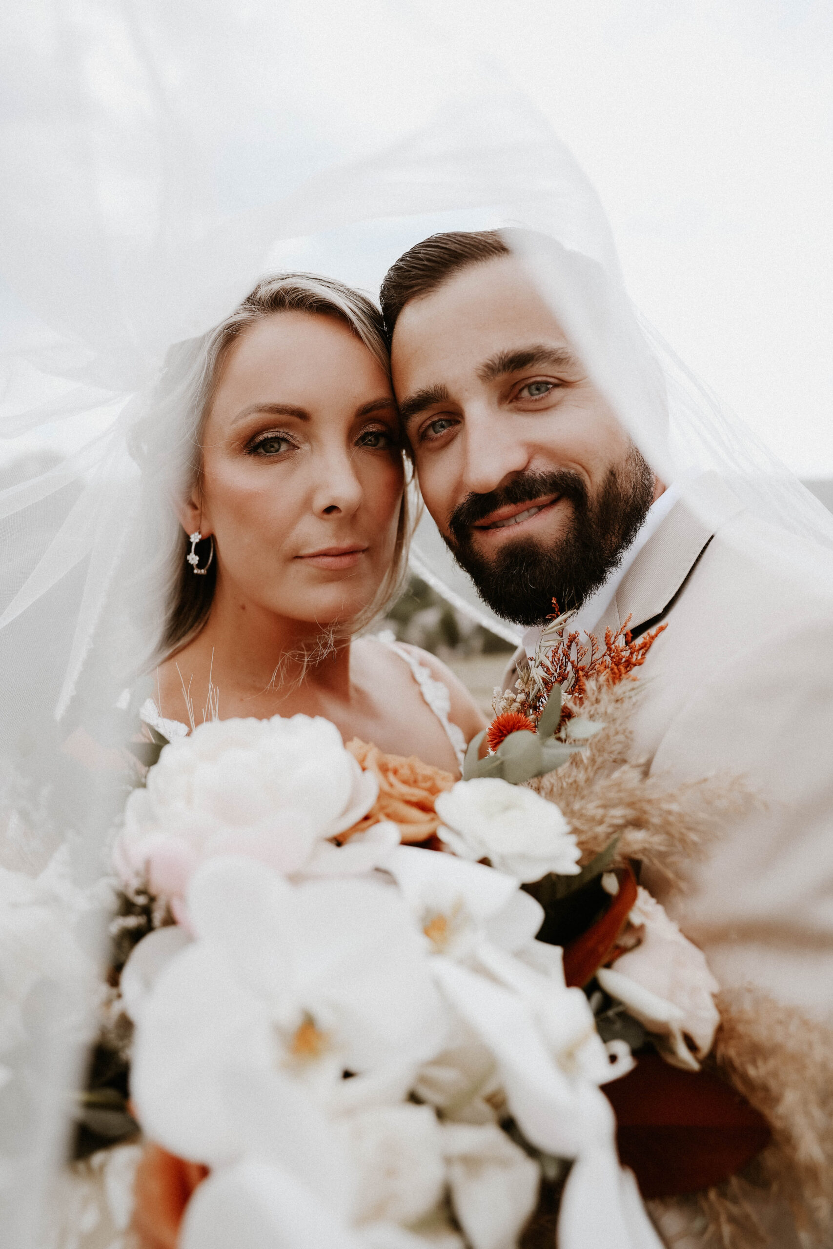 bride and groom portrait under the veil 