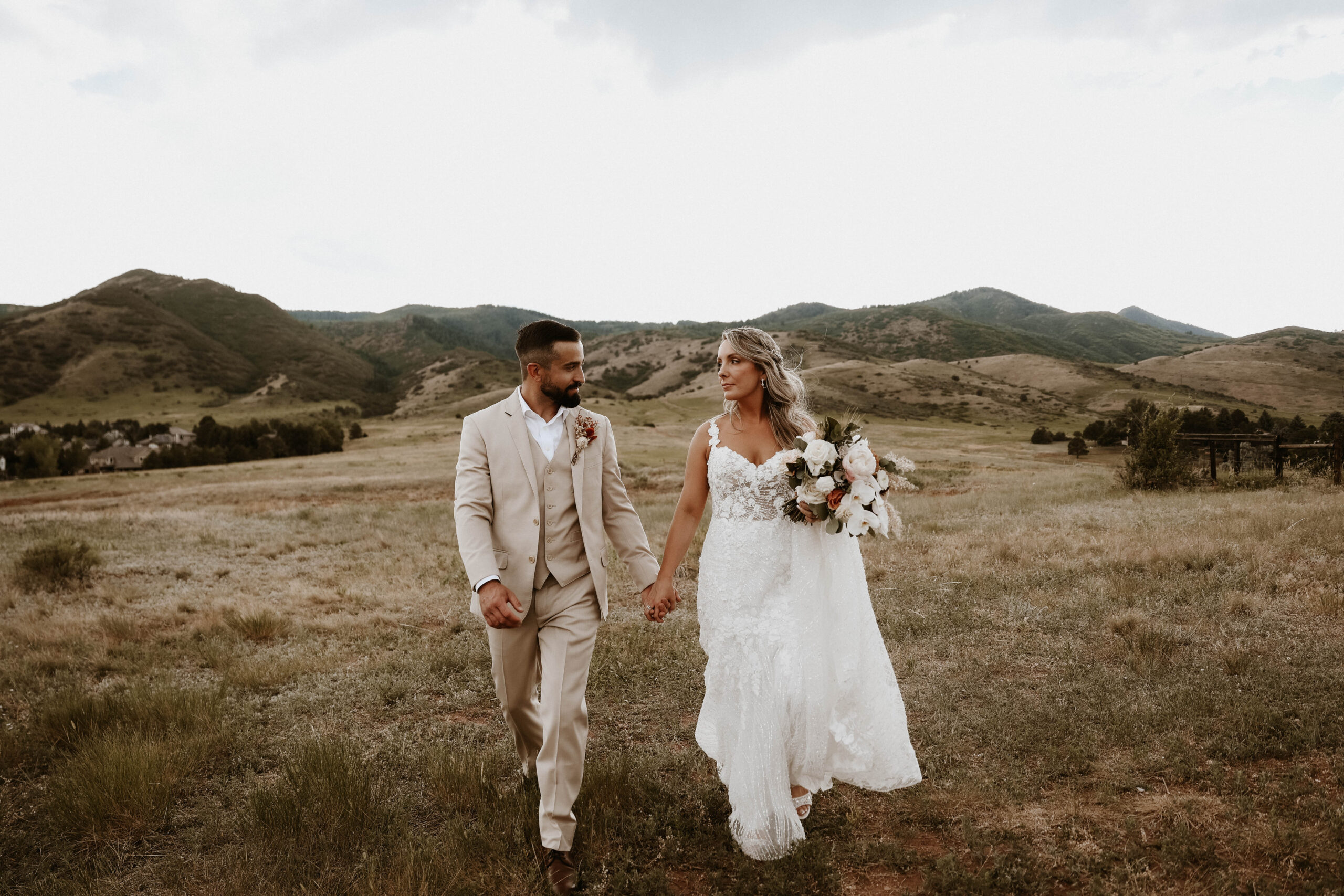 bride and groom walking and holding hands 