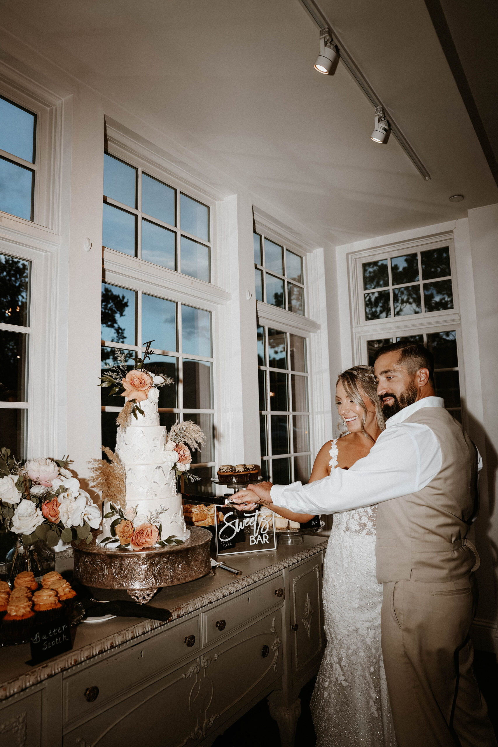 manor house wedding couple cutting their cake 