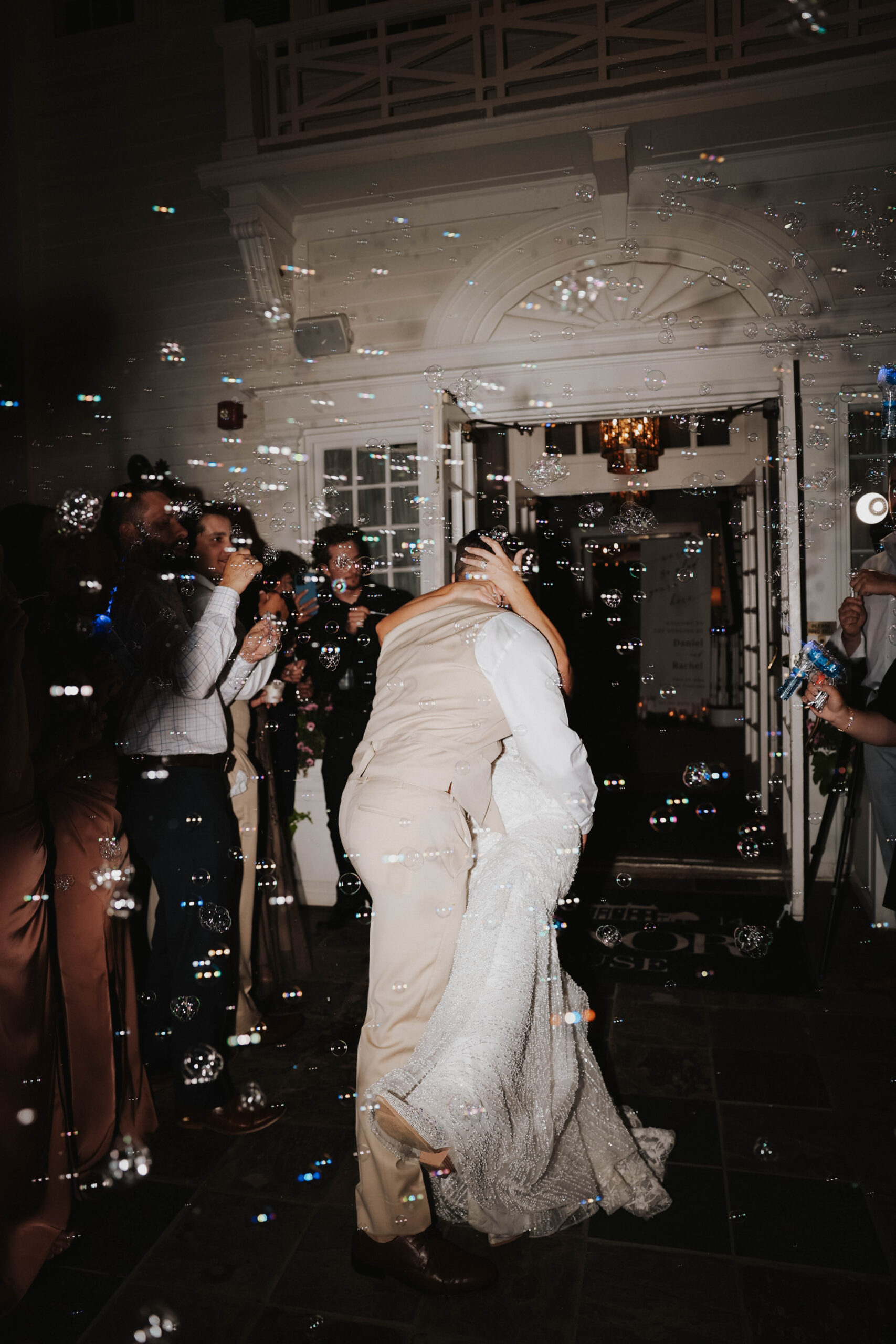 bride and groom kissing at their bubble exit