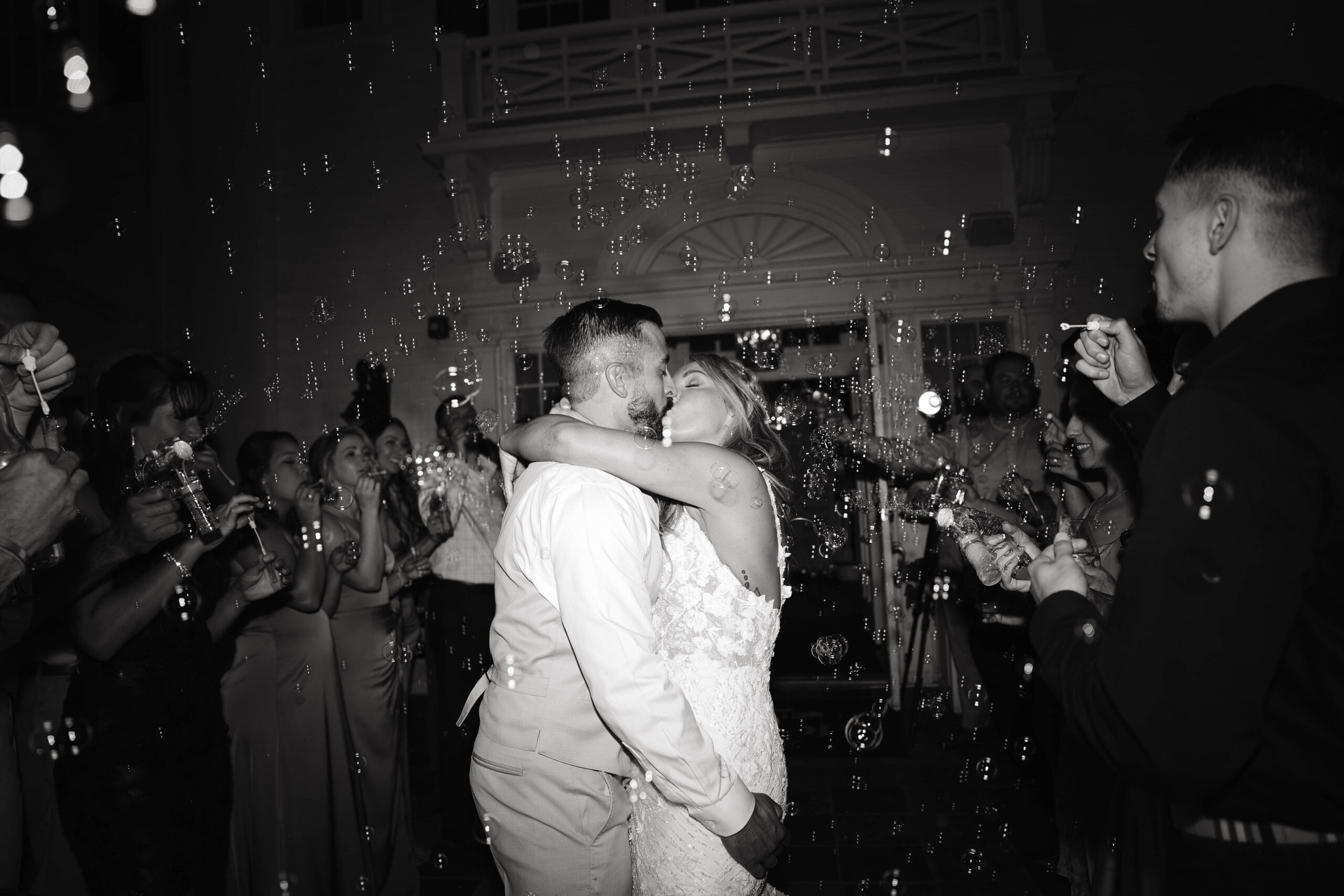 bride and groom bubble exit kiss