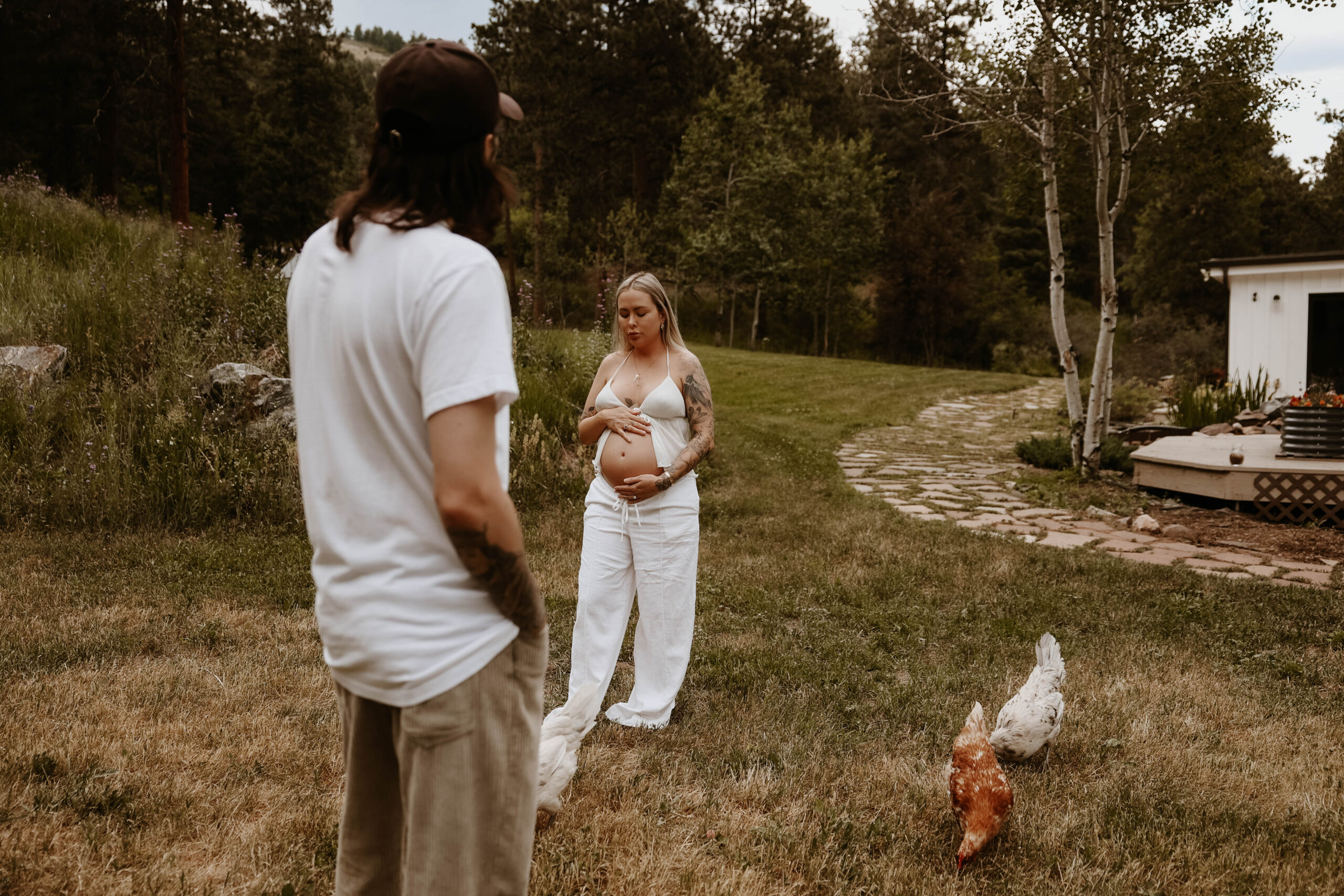 a couple at their home, with their, chickens during a Denver Maternity Photography session 