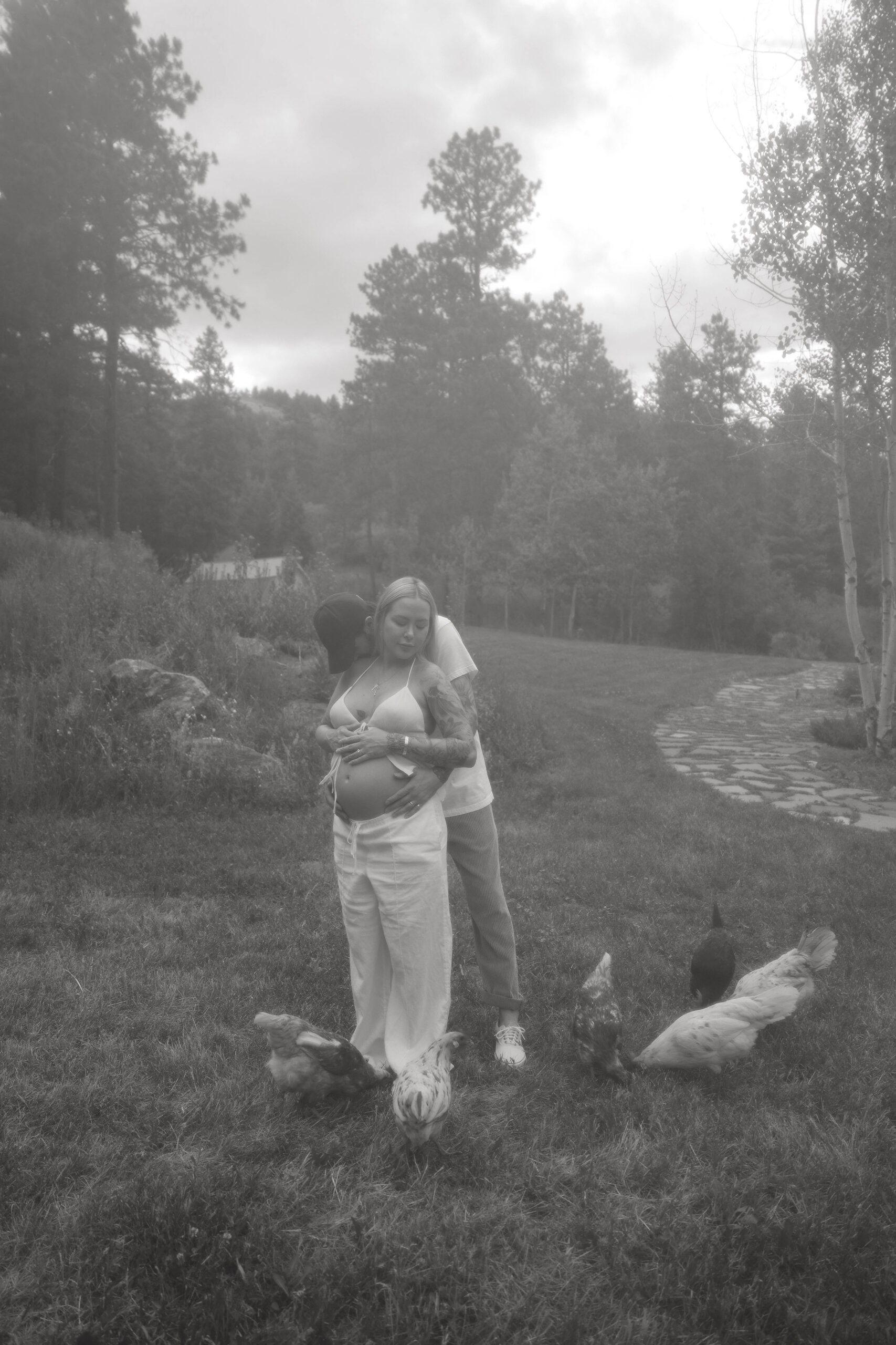 a couple holding each other and kissing during their Denver Maternity Photography session 