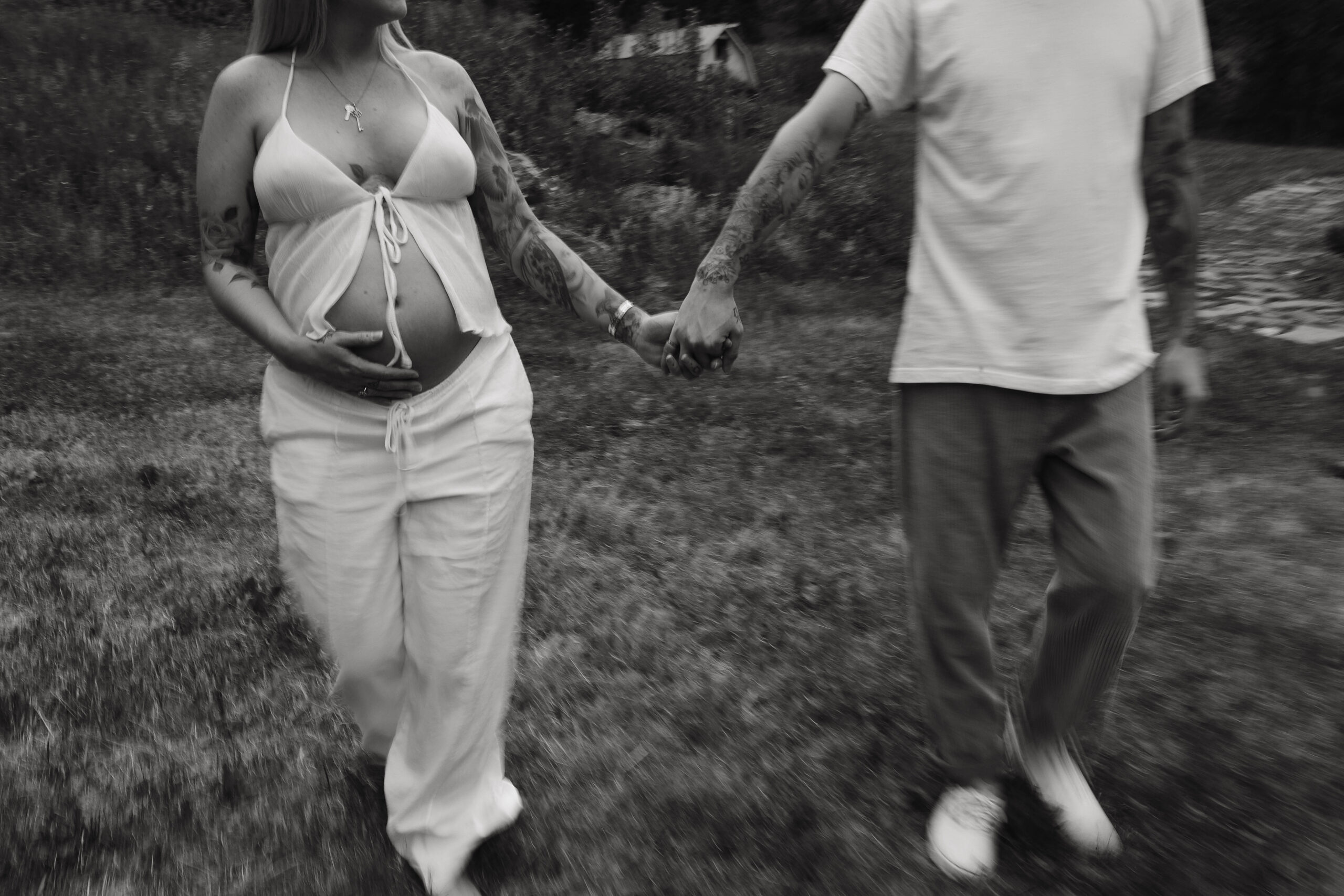 a couple holding hands during their maternity session