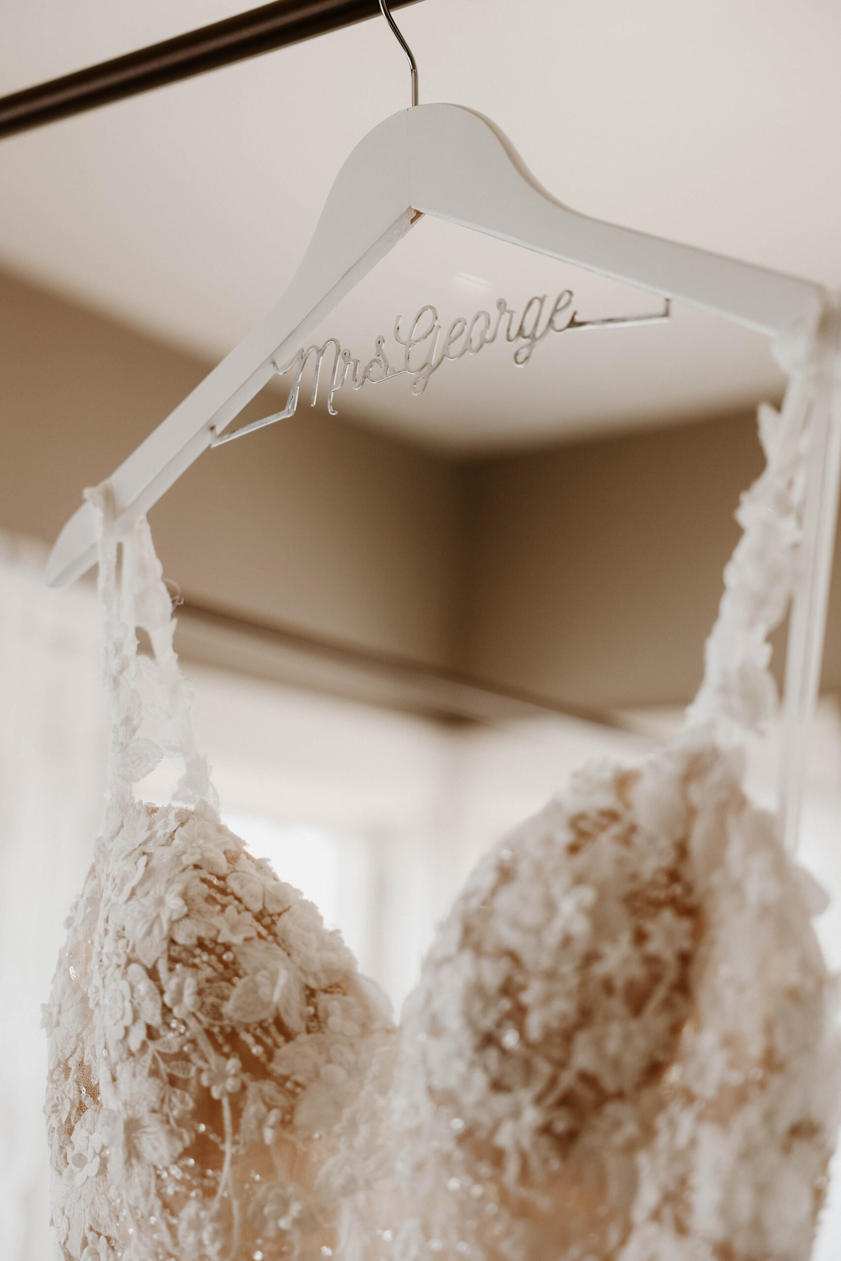 close up of wedding dress and hanger detail